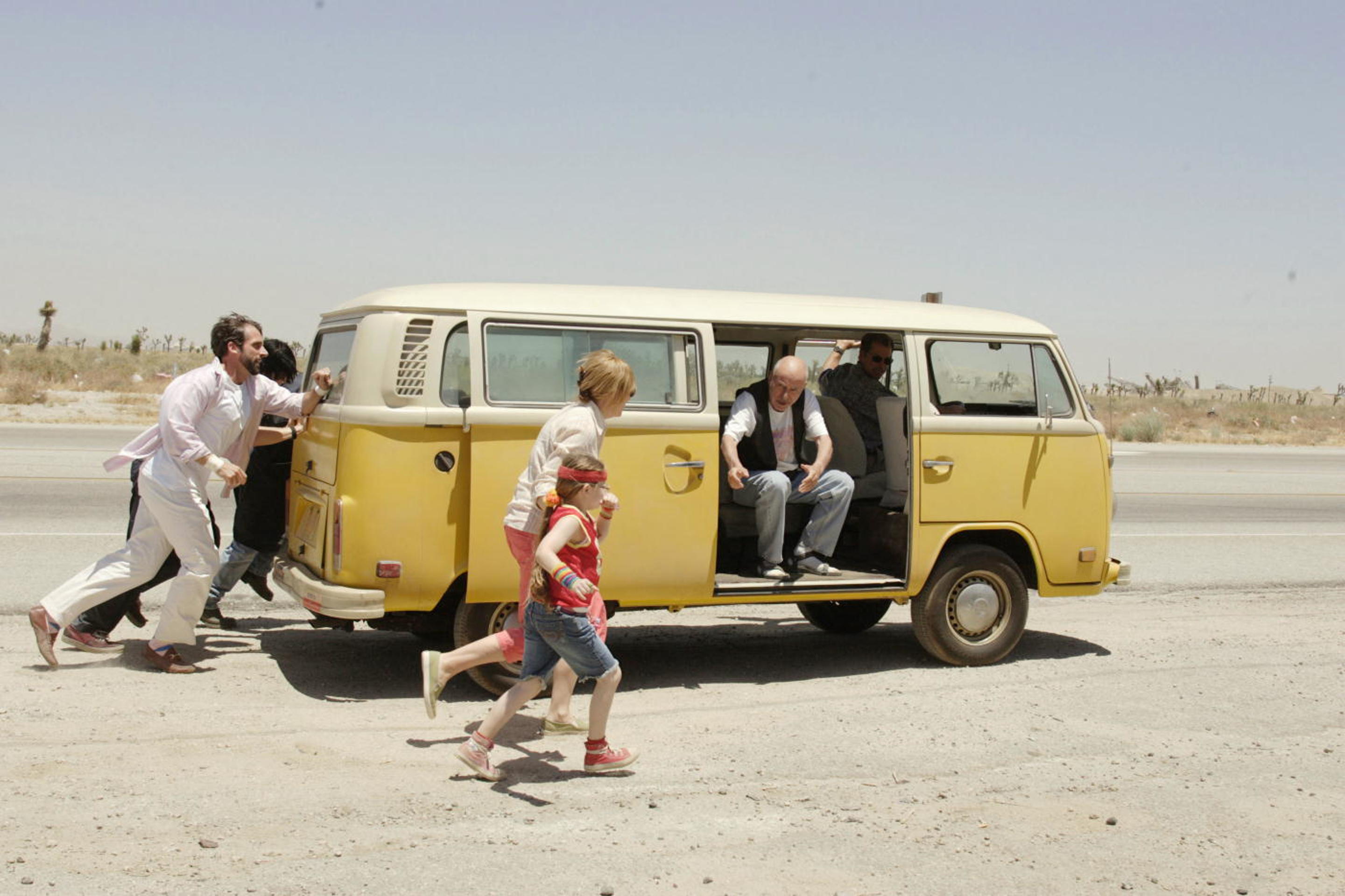 Steve Carell and others pushing a yellow van HD Wallpaper