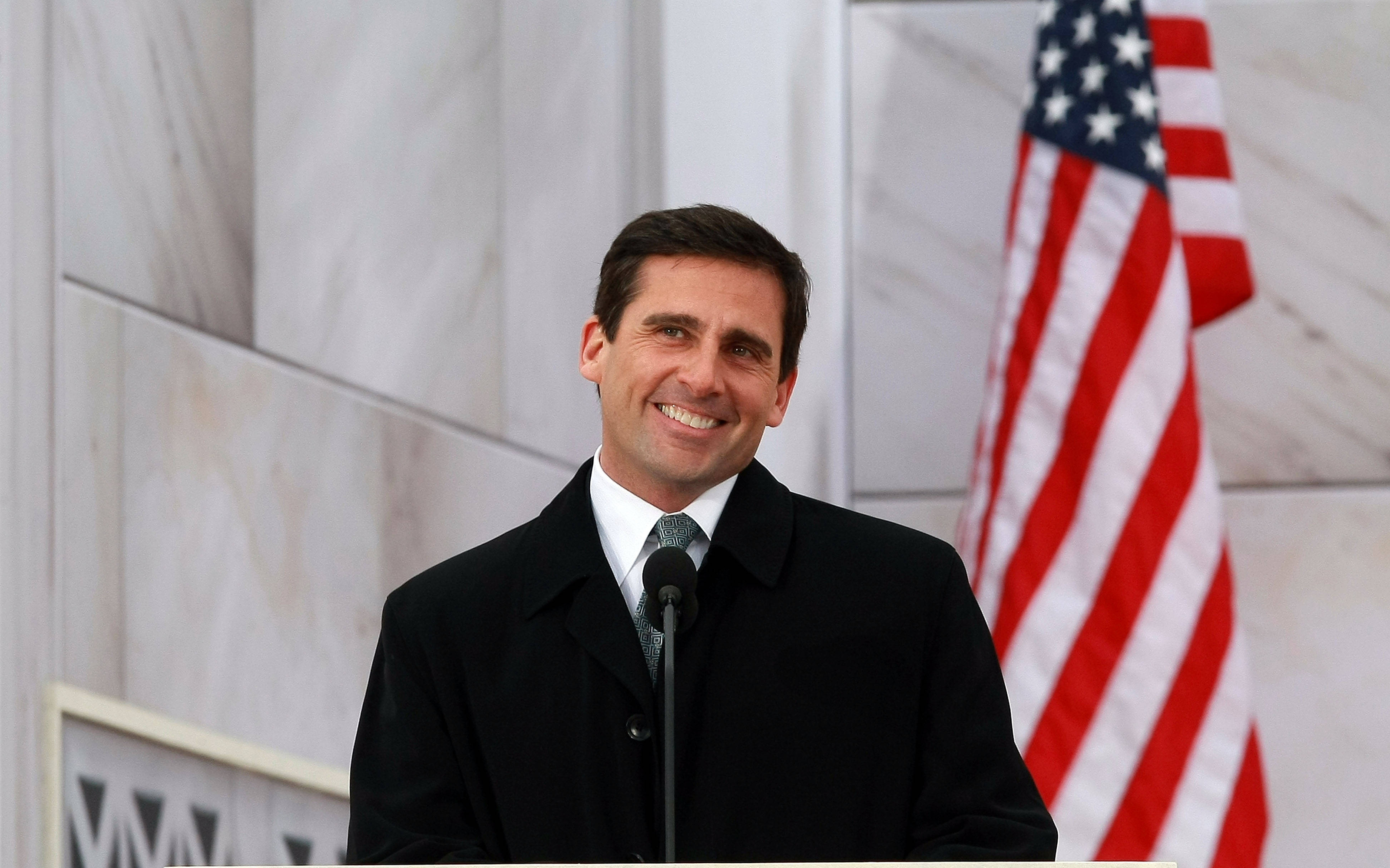 Steve Carell at a podium with American flag HD Wallpaper