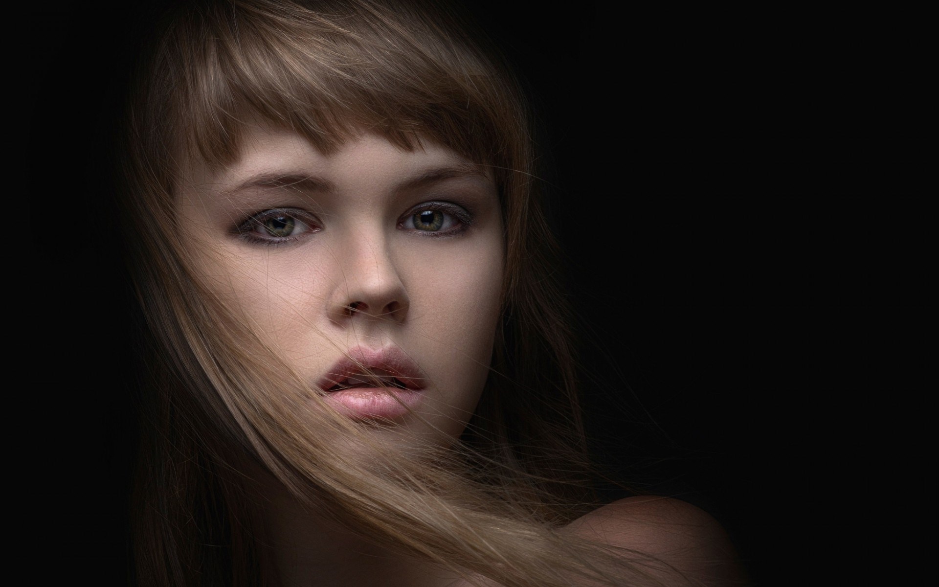 Woman with hair blowing across her face HD Wallpaper