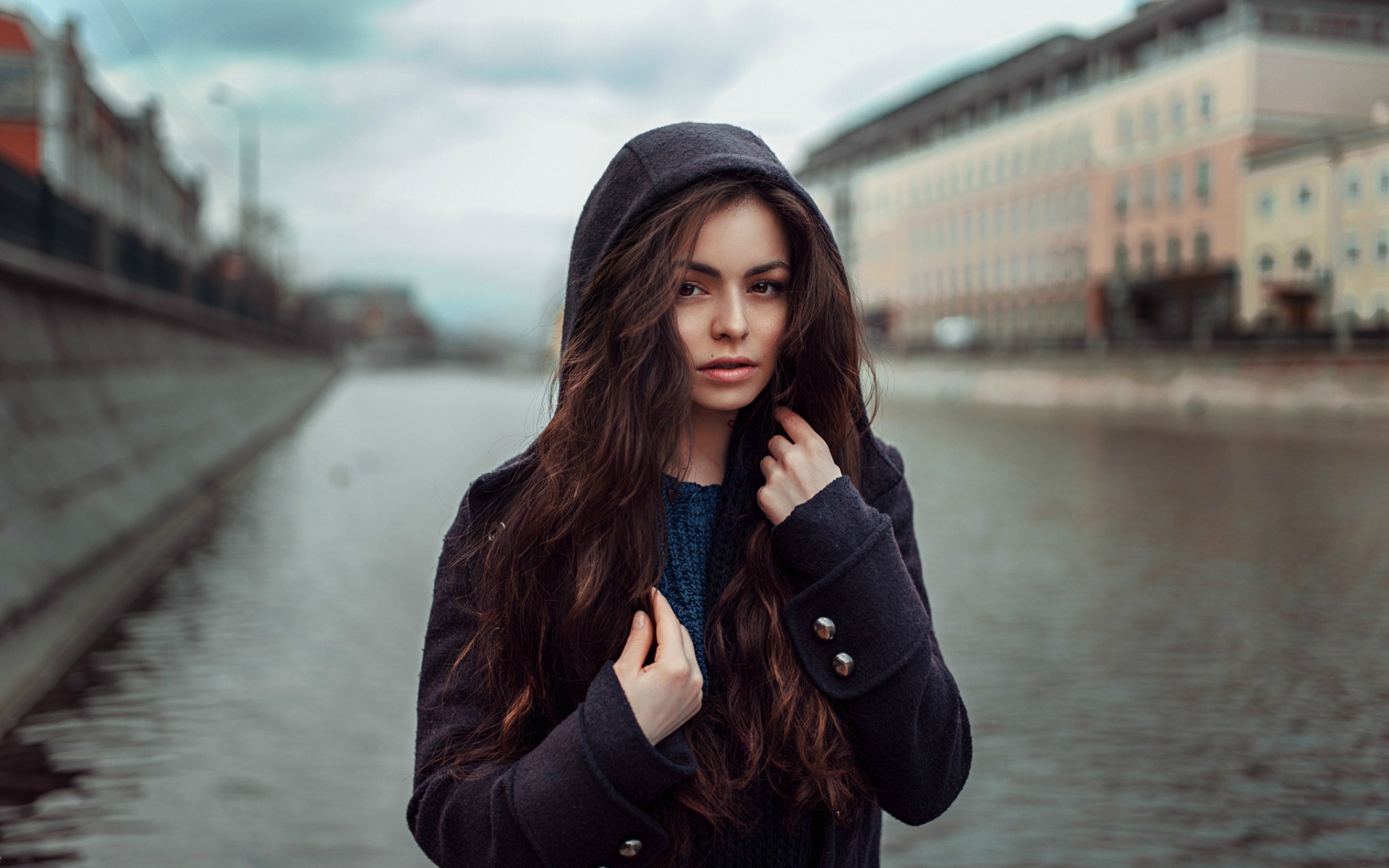 Woman in a hooded coat by a canal HD Wallpaper