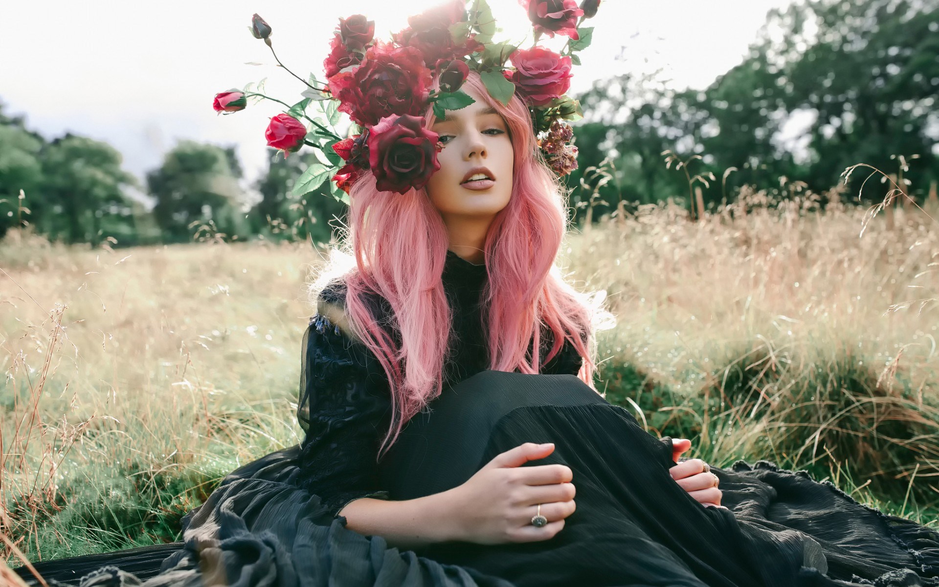 Woman with pink hair and flower crown in a field HD Wallpaper