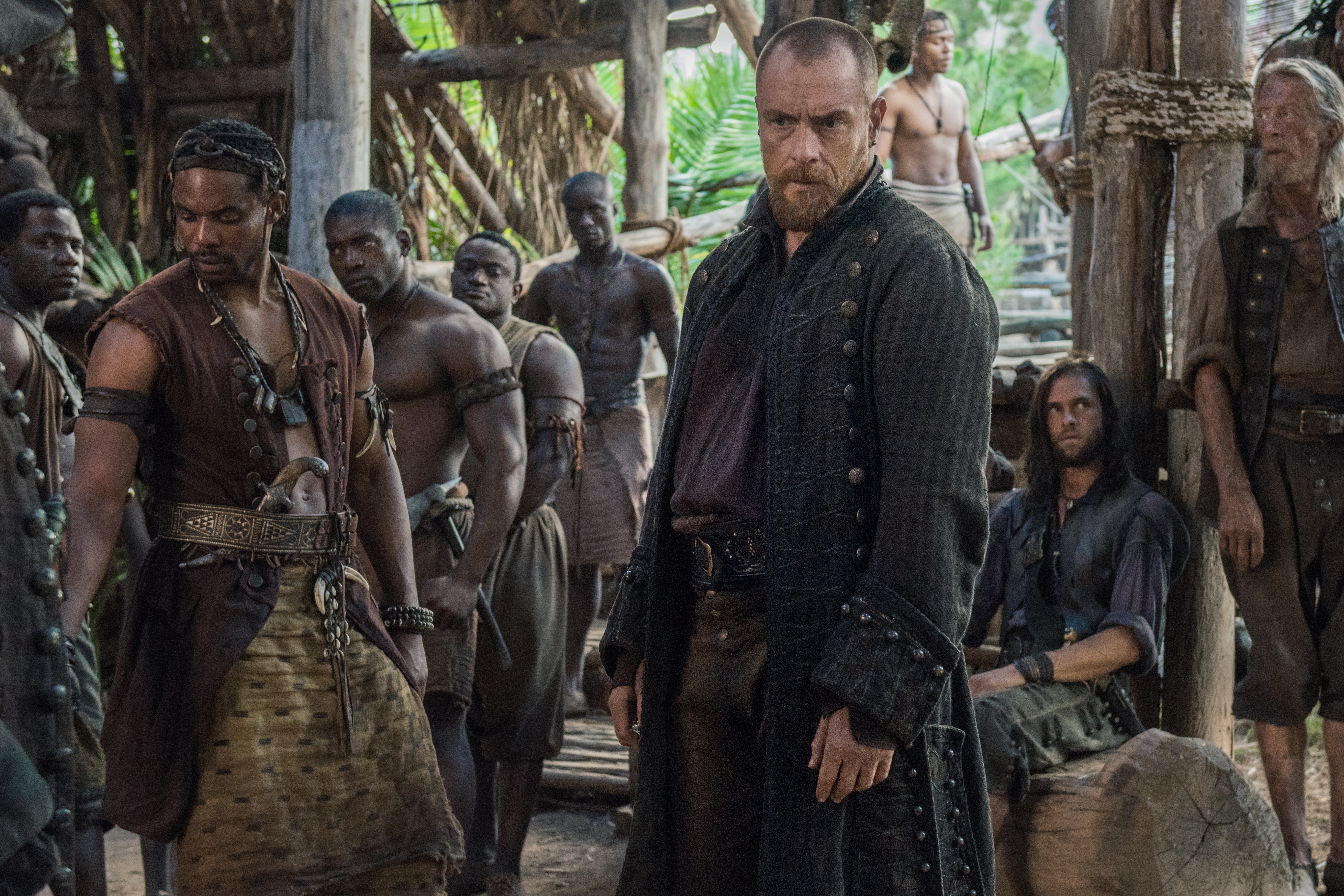 Toby Stephens and a group of men on a tropical island HD Wallpaper