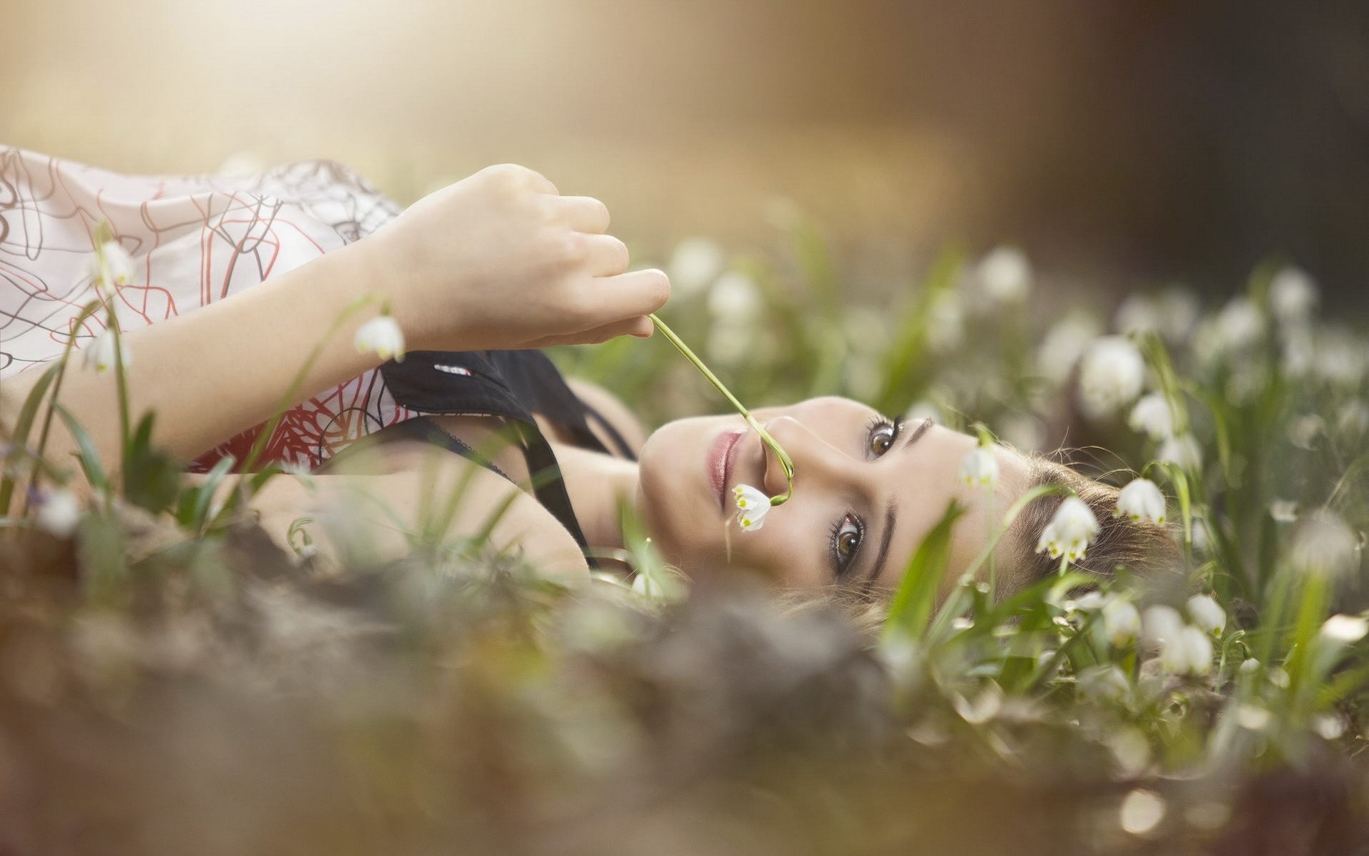 Woman lying in a field of flowers HD Wallpaper
