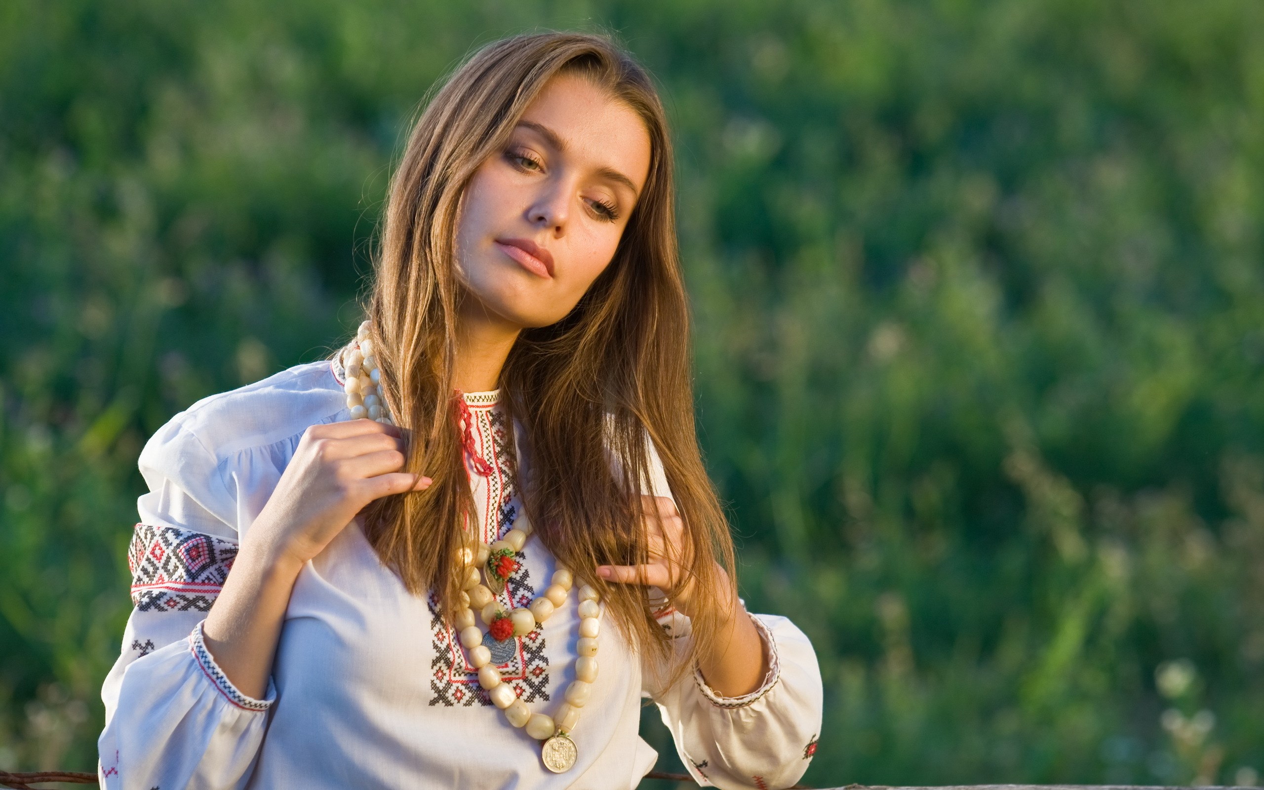 Woman in traditional Ukrainian clothing with beaded necklace HD Wallpaper