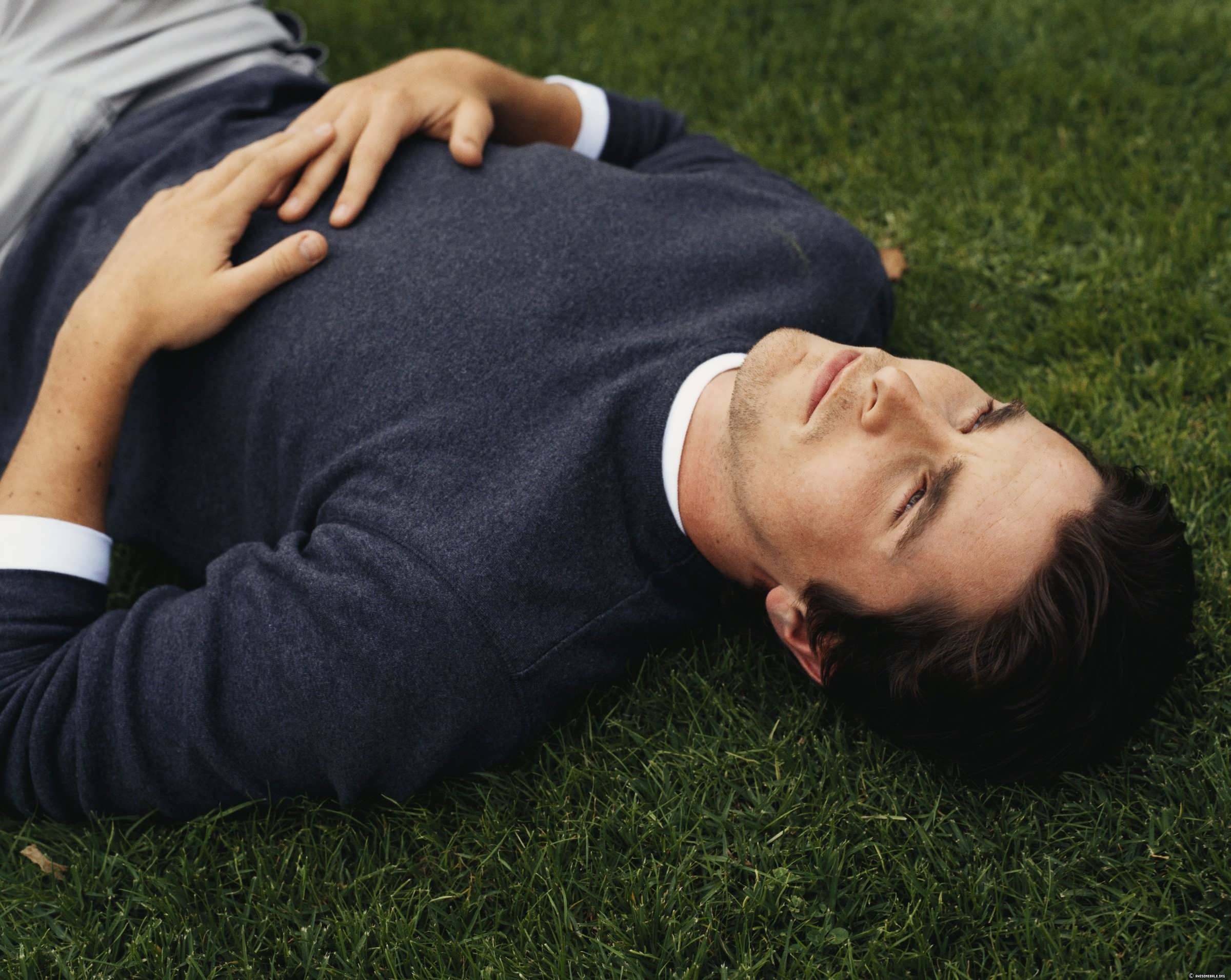 Christian Bale lying on grass HD Wallpaper