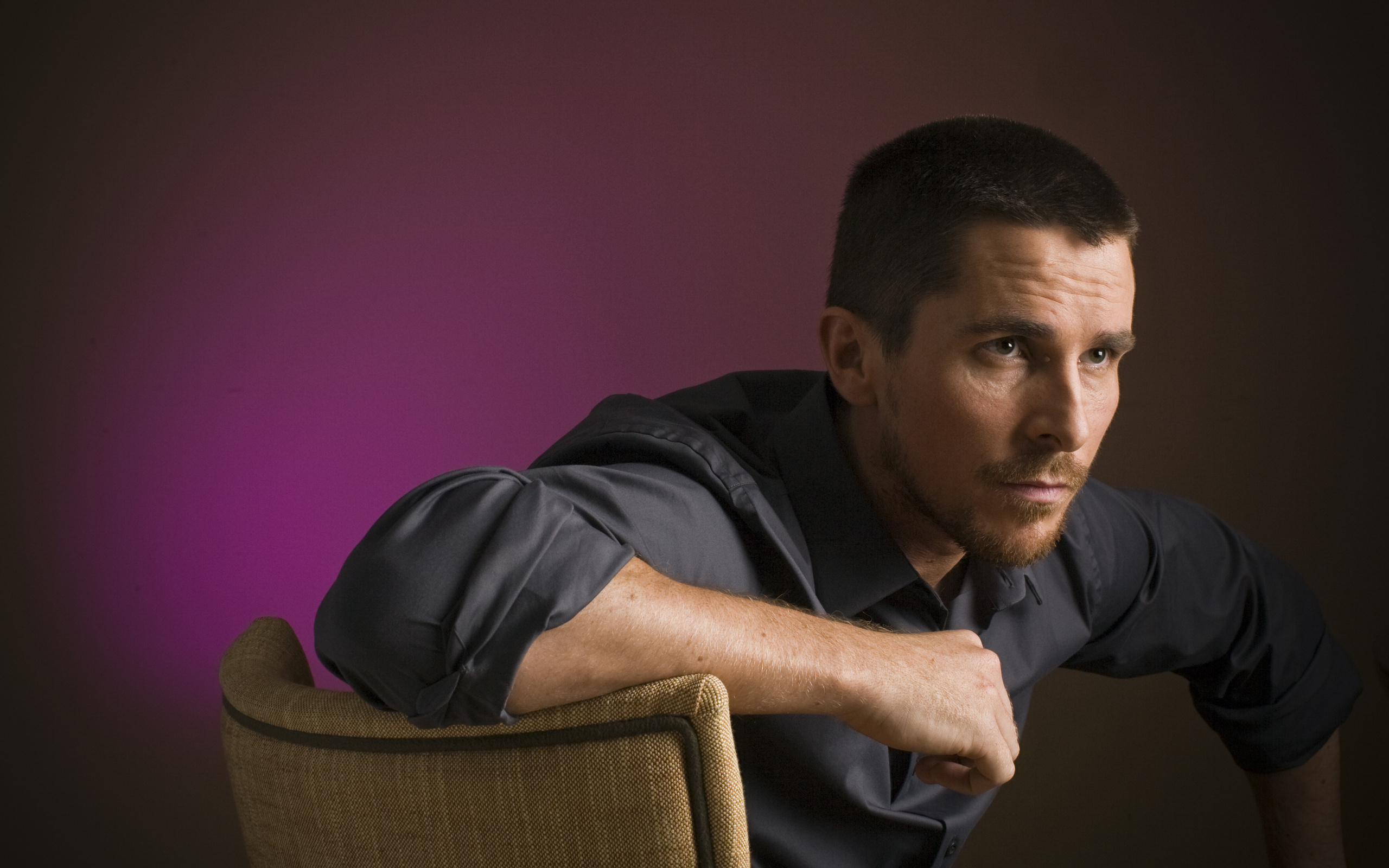 Christian Bale sitting on a chair HD Wallpaper