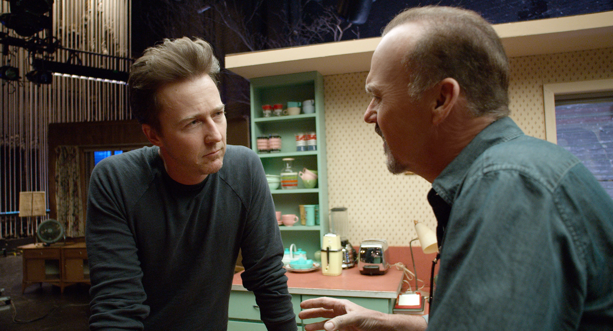 Edward Norton and Michael Keaton in a kitchen set HD Wallpaper