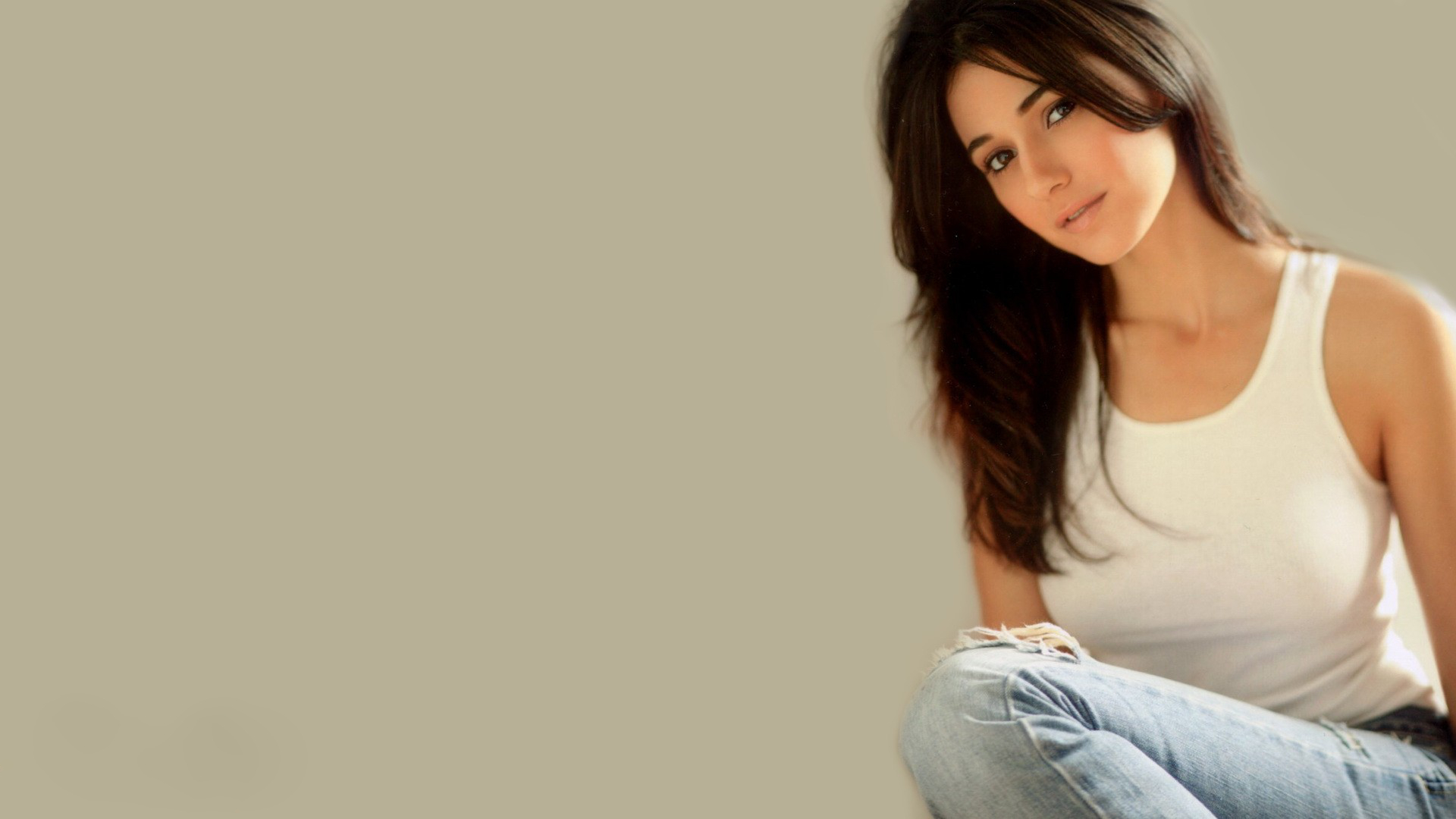 Emmanuelle Chriqui in white tank top and jeans HD Wallpaper