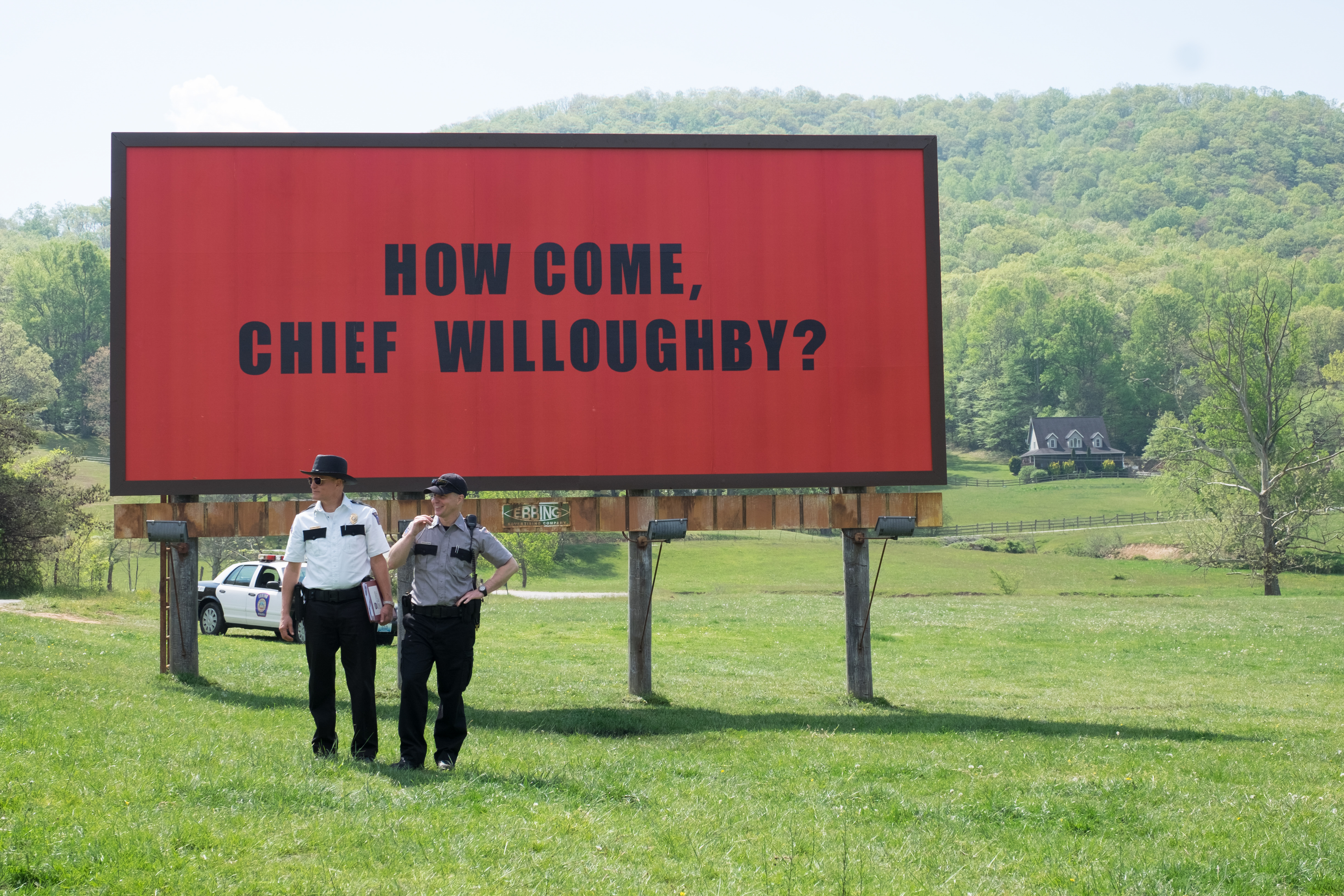 Sam Rockwell and another man in front of a billboard HD Wallpaper