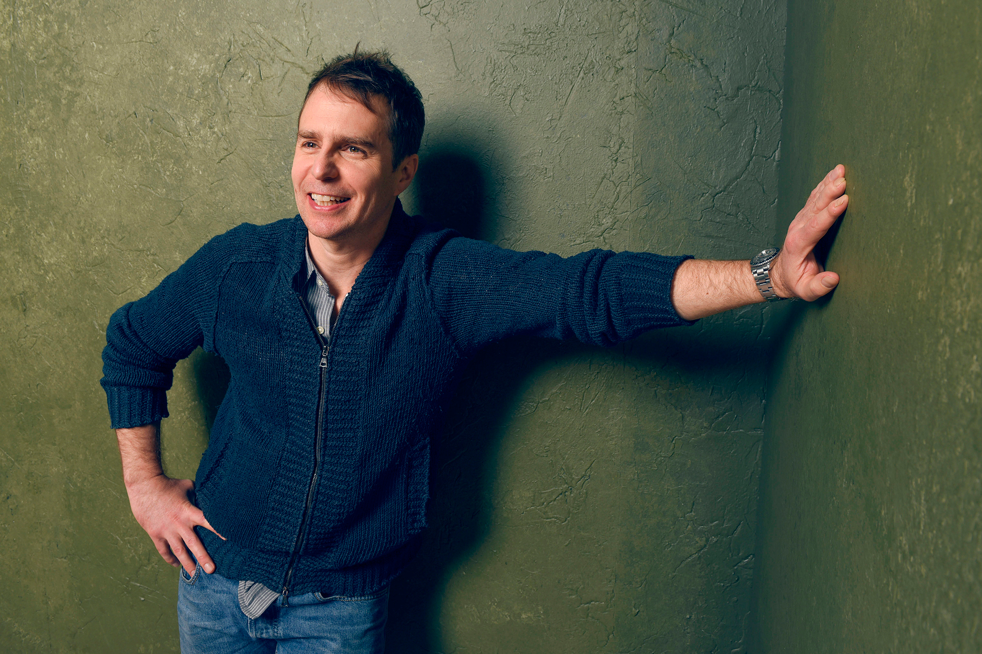 Sam Rockwell leaning against a green wall HD Wallpaper