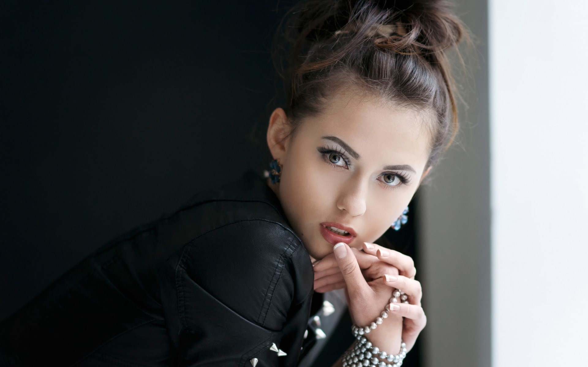 Woman with dark hair and leather jacket HD Wallpaper