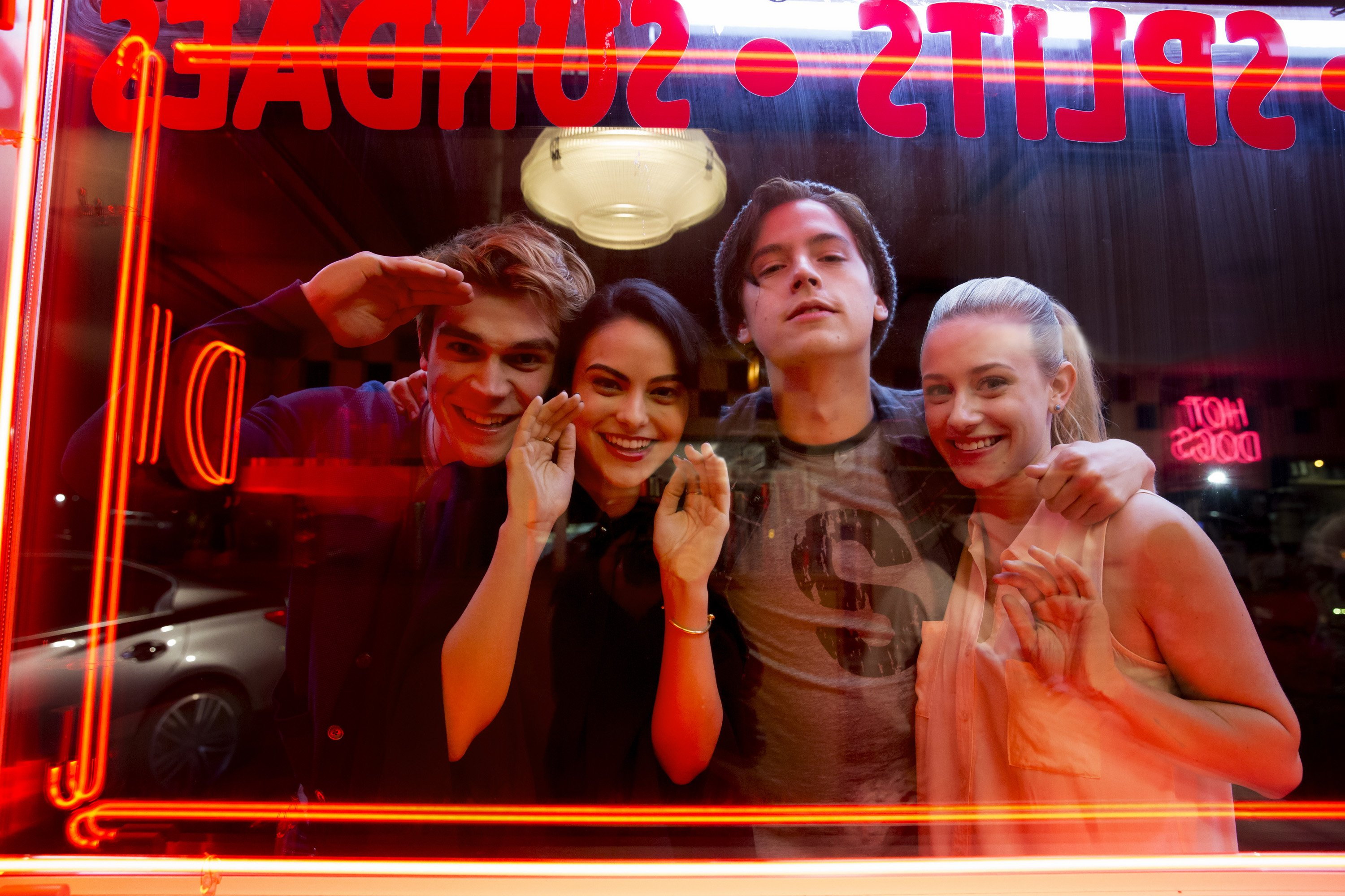 Four friends in front of a diner window HD Wallpaper