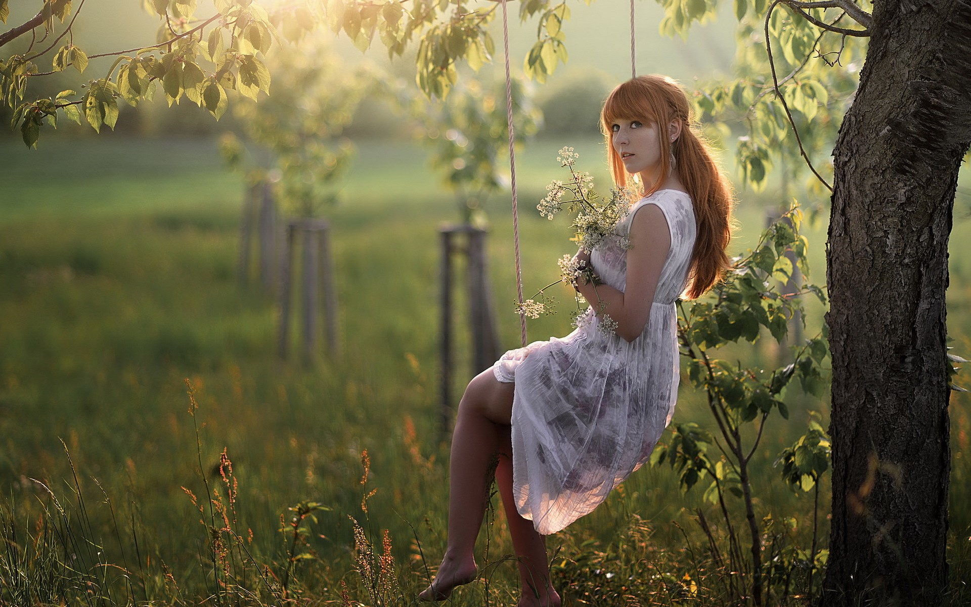 Woman on a swing holding flowers HD Wallpaper