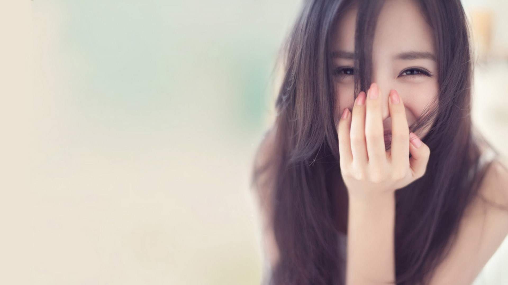 Young woman with dark hair smiling HD Wallpaper