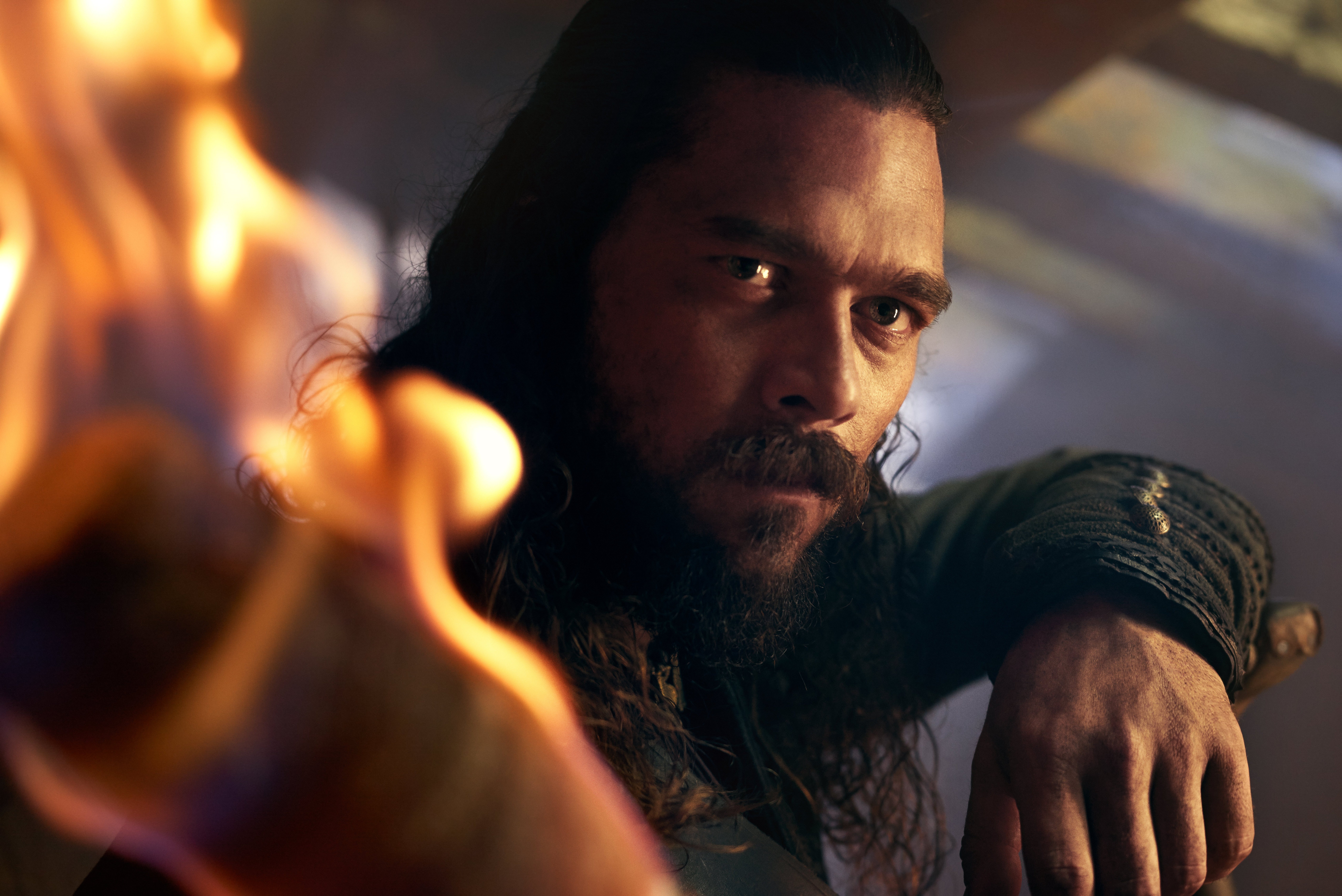 Luke Arnold in front of fire HD Wallpaper