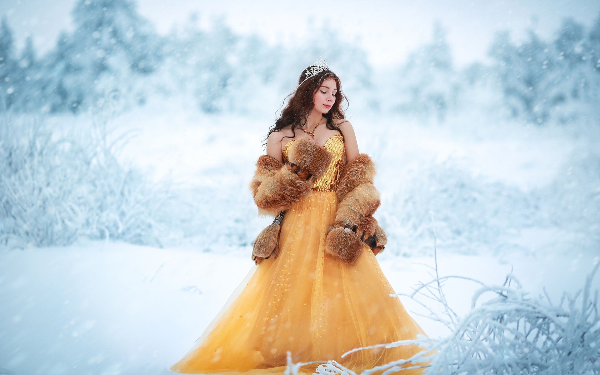 Woman in yellow dress and fur coat in snow HD Wallpaper