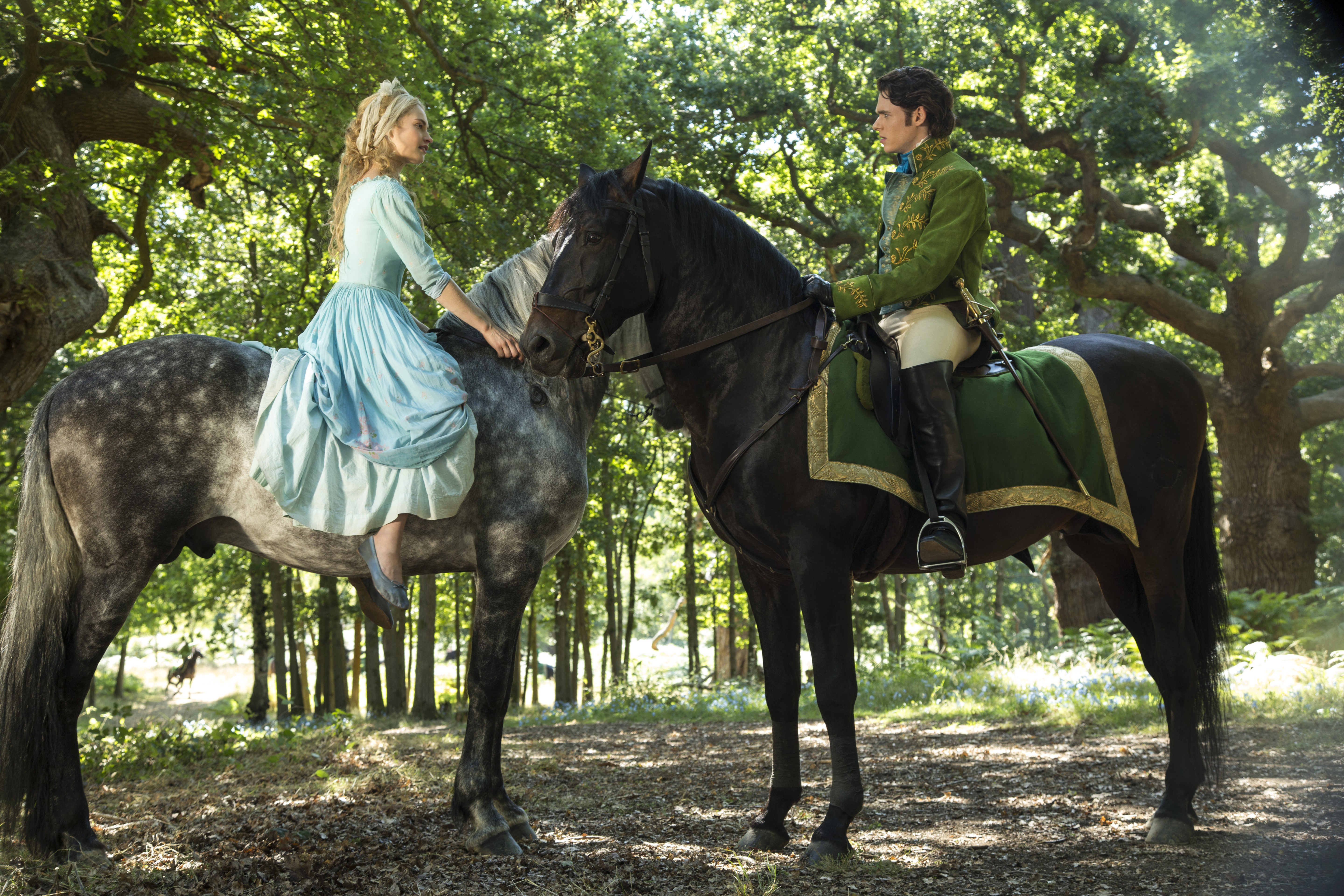 Lily James on horseback in a forest HD Wallpaper