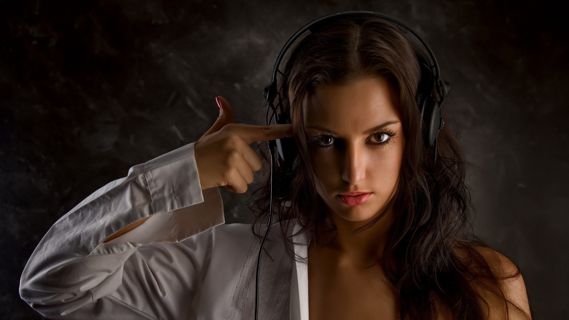 Woman with headphones pointing finger gun to head HD Wallpaper