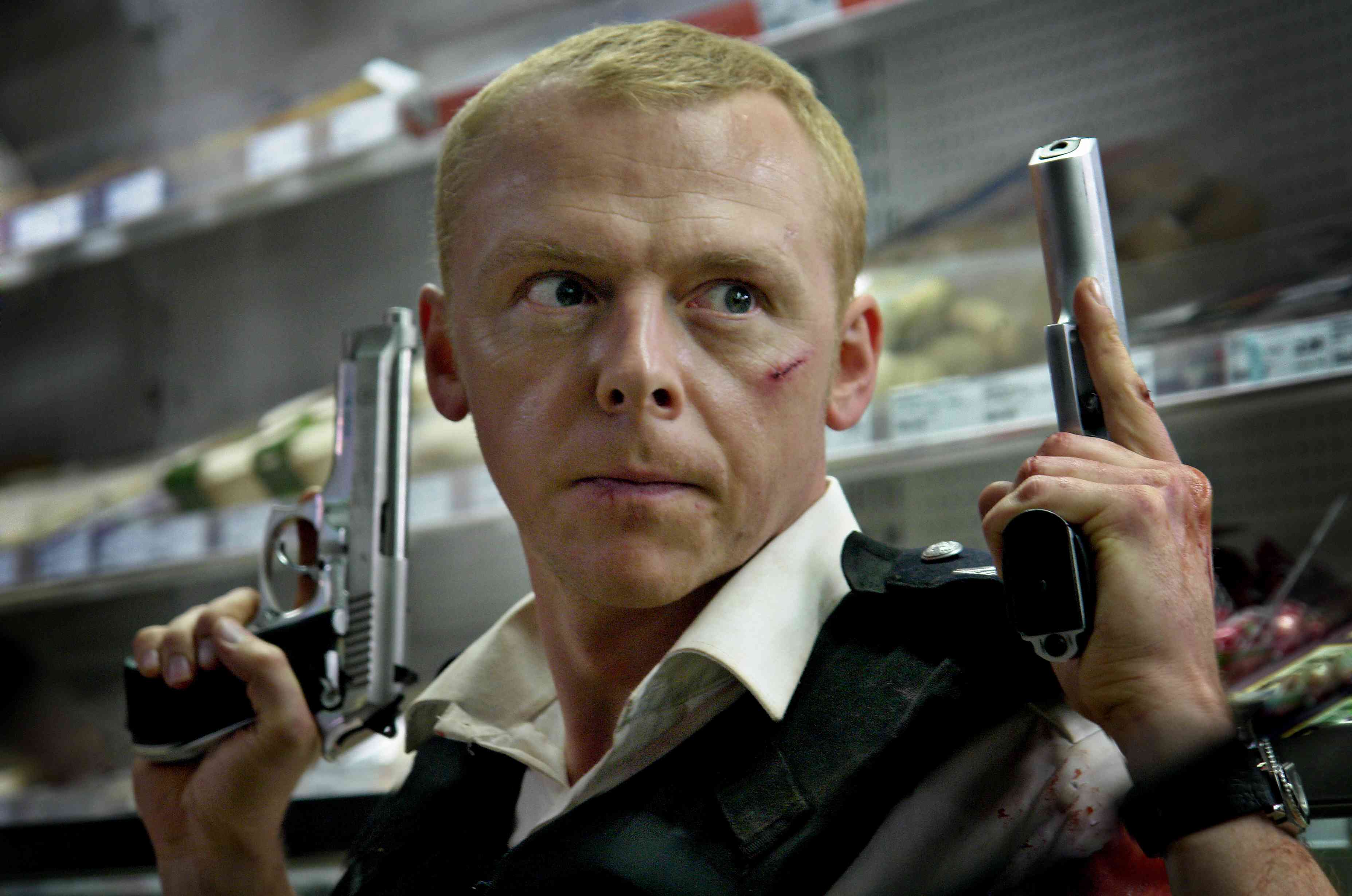 Simon Pegg holding two handguns HD Wallpaper