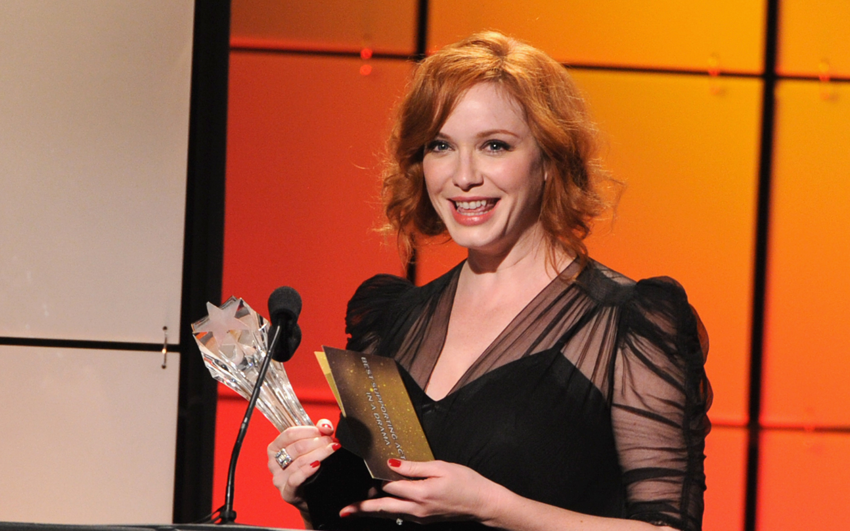 Christina Hendricks holding an award HD Wallpaper