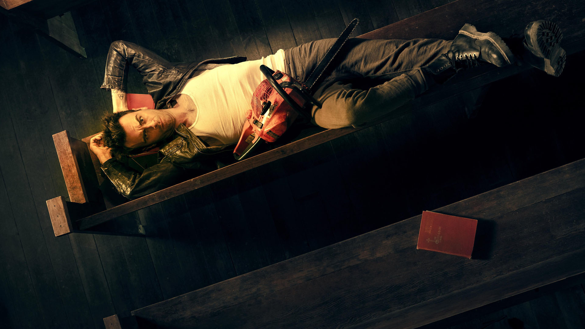 Joseph Gilgun with Chainsaw and Book HD Wallpaper