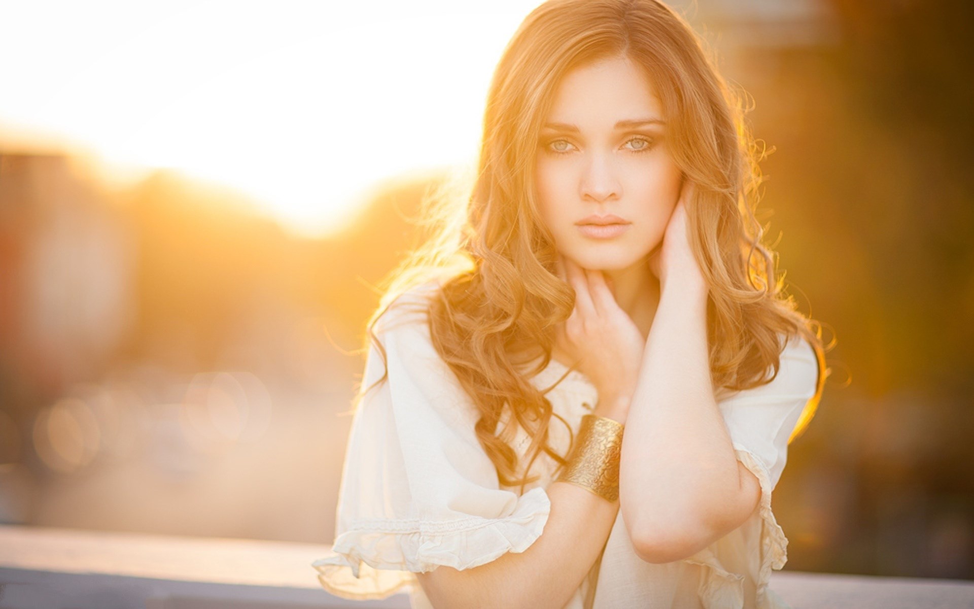 Woman with long wavy hair in golden hour light HD Wallpaper