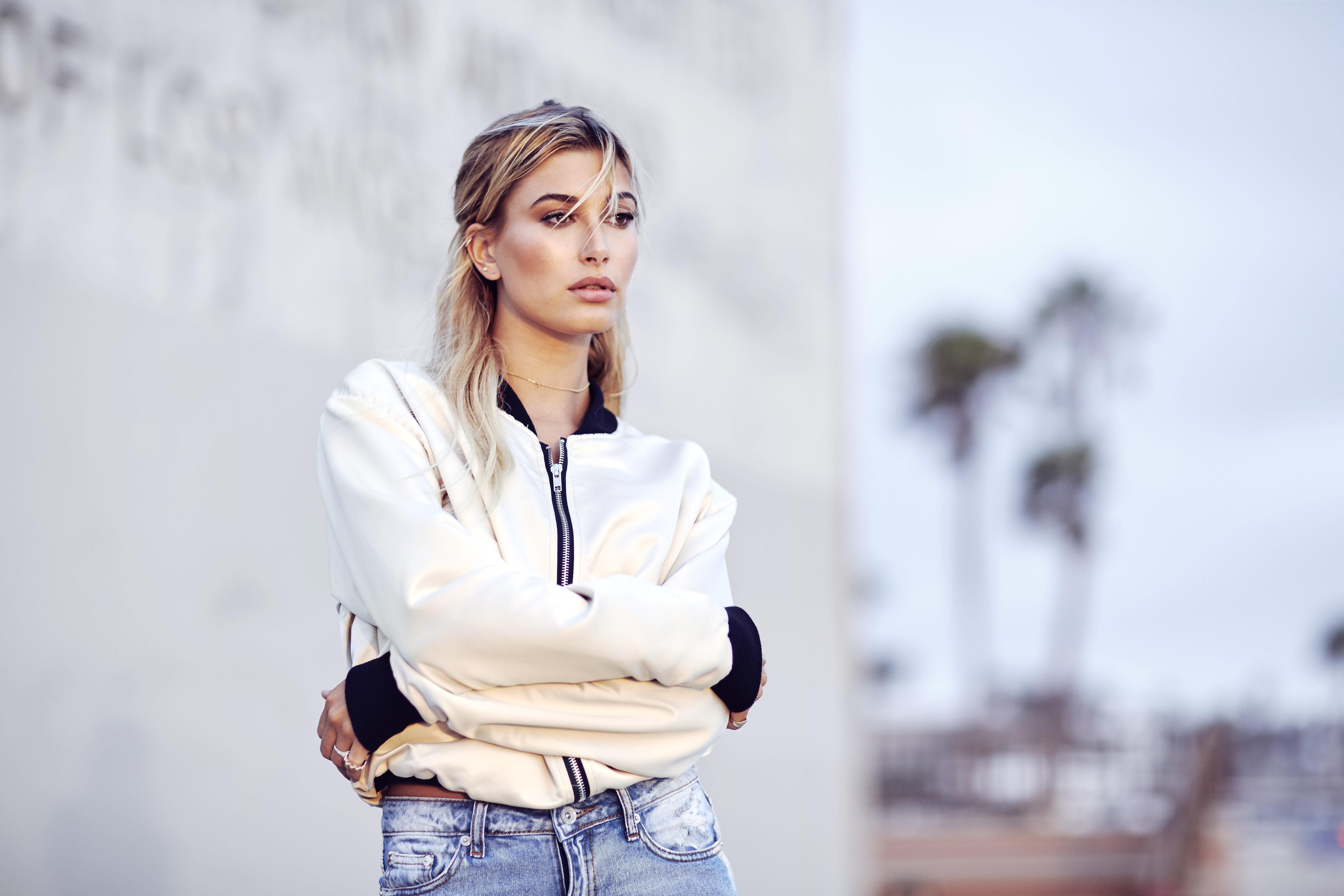 Hailey Baldwin in a bomber jacket and jeans HD Wallpaper