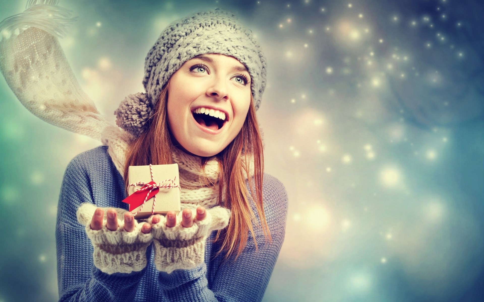 Woman in winter clothes holding a gift HD Wallpaper