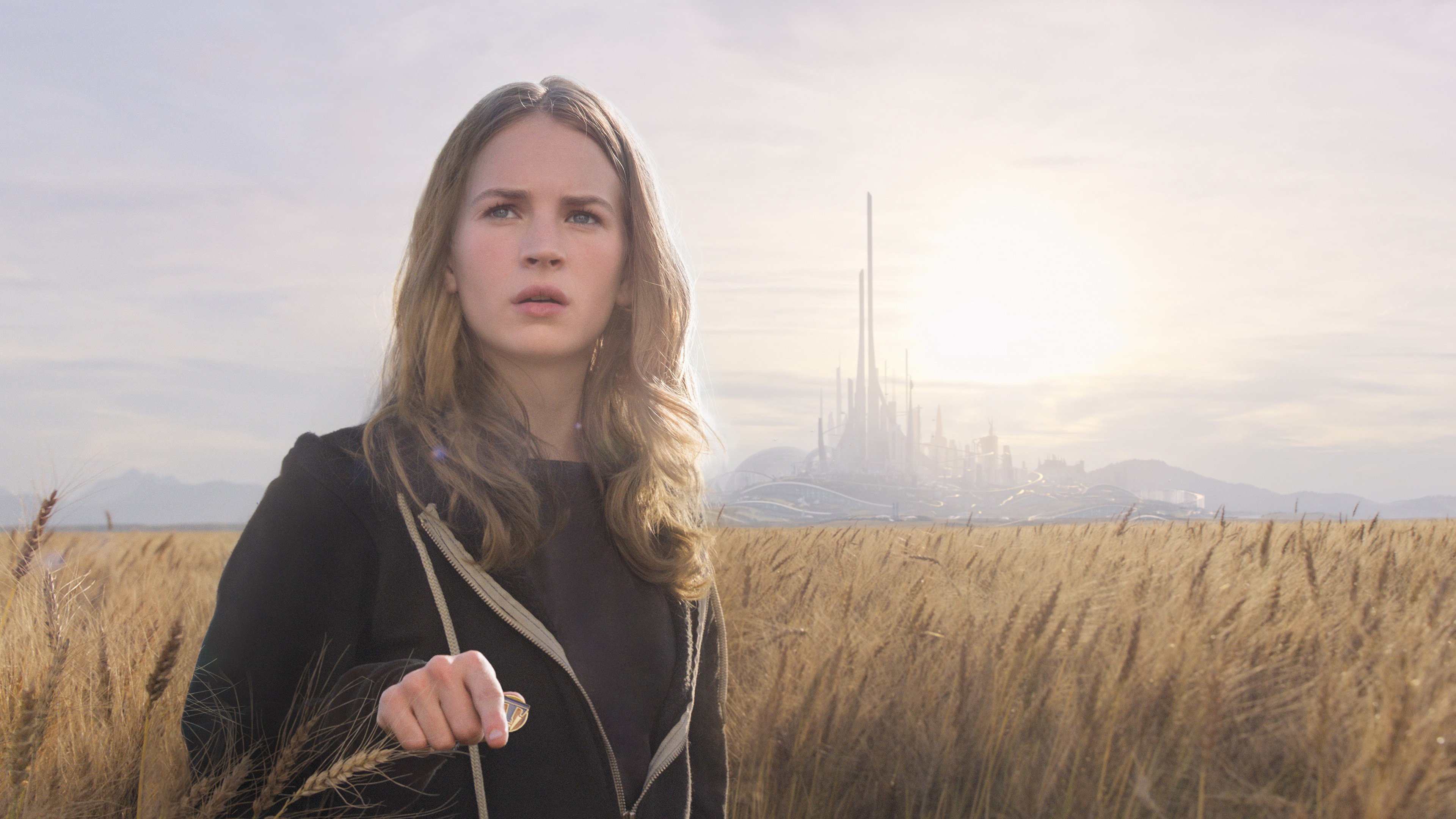 Britt Robertson in a wheat field with a futuristic city HD Wallpaper