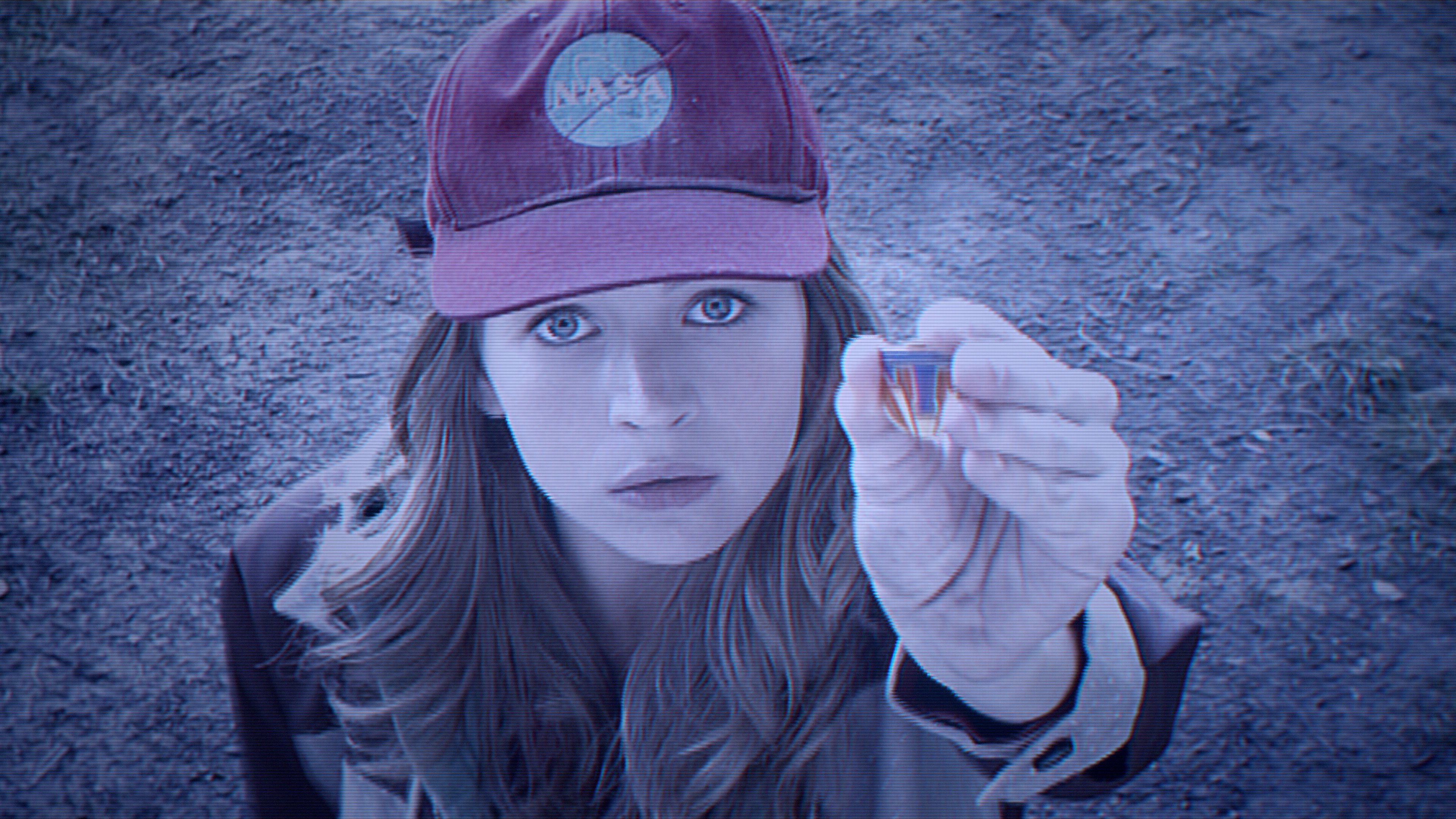 Britt Robertson holding a small object HD Wallpaper