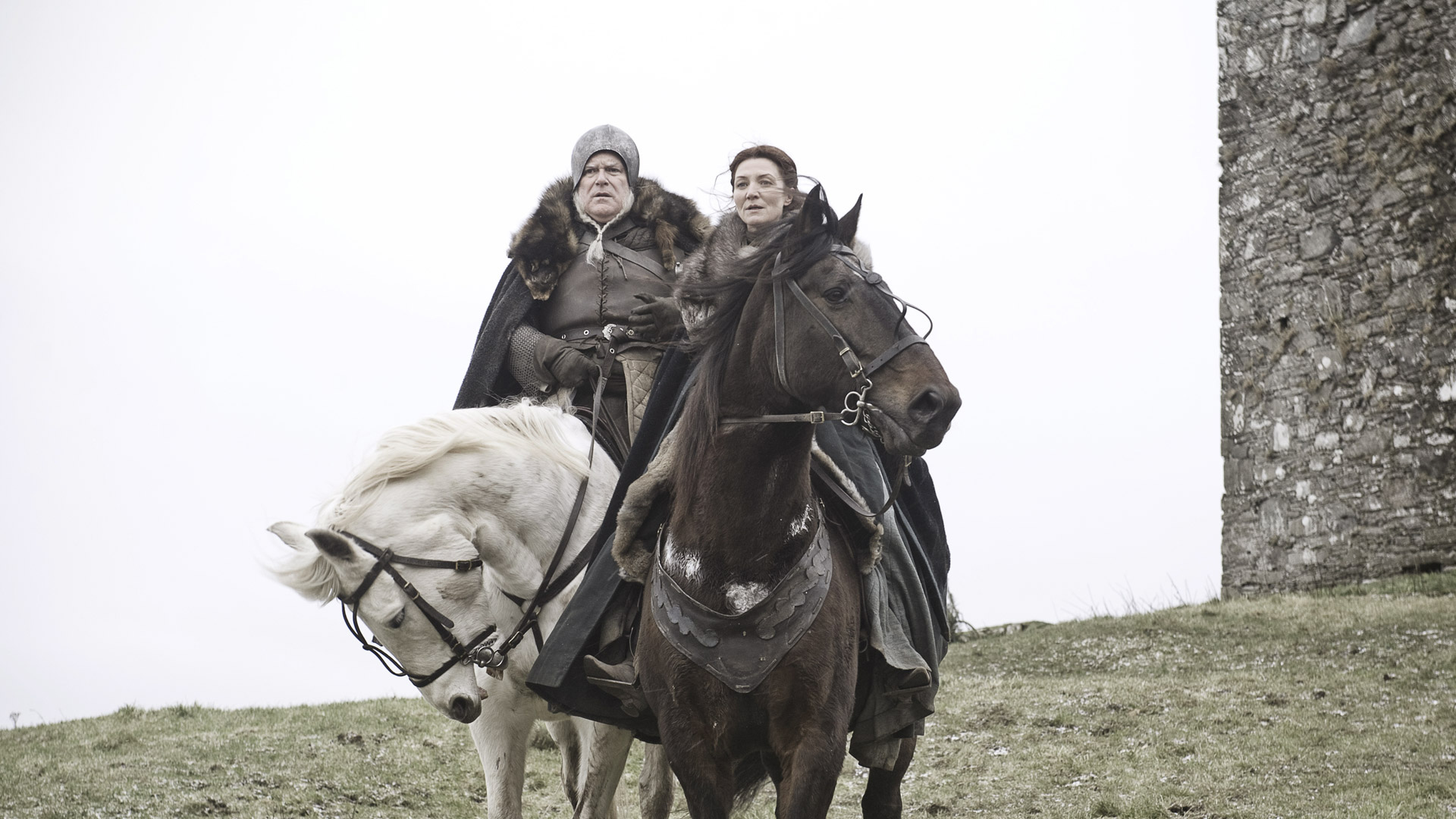 Michelle Fairley and man on horseback near castle HD Wallpaper