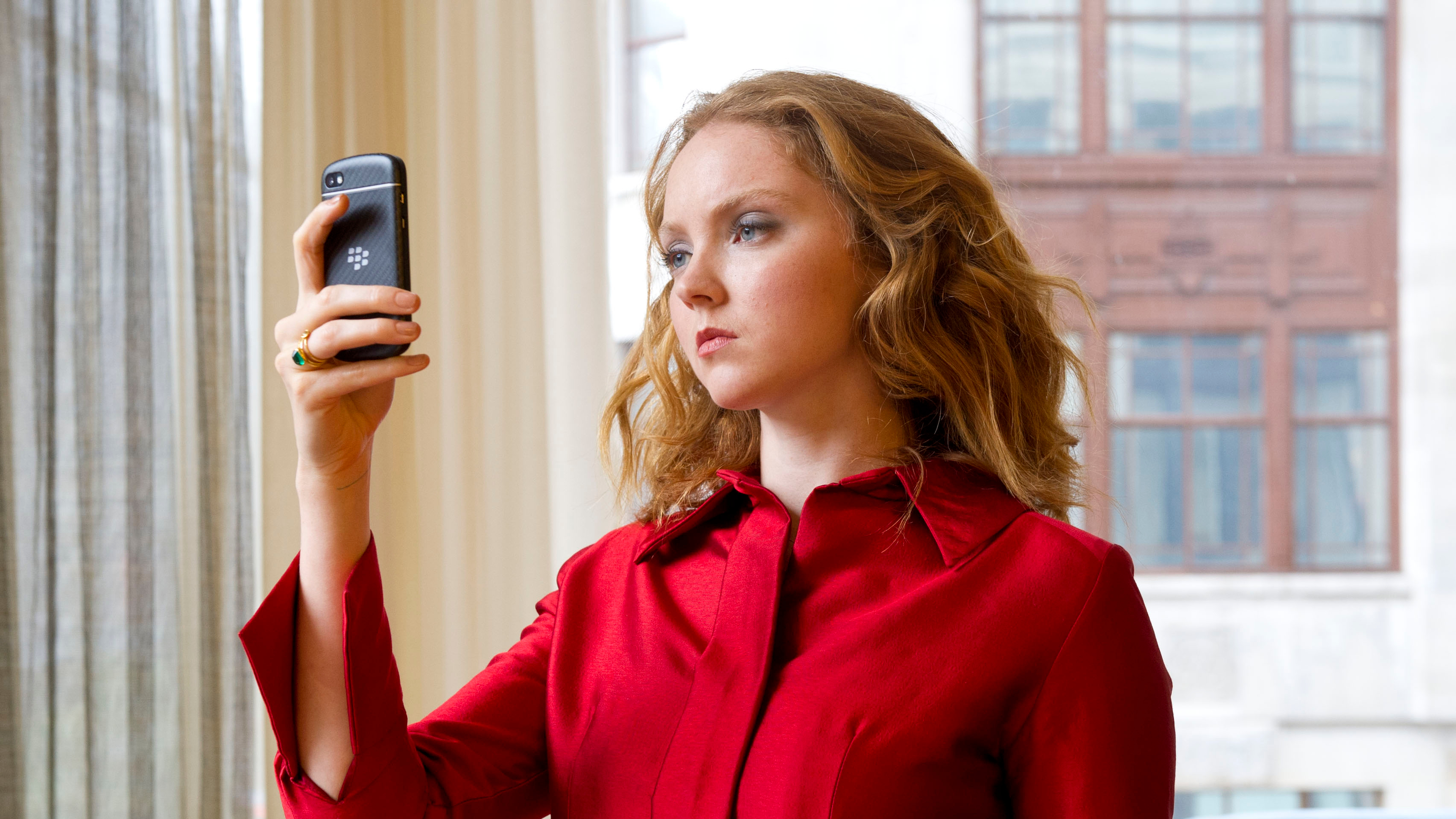 Lily Cole holding a Blackberry phone HD Wallpaper