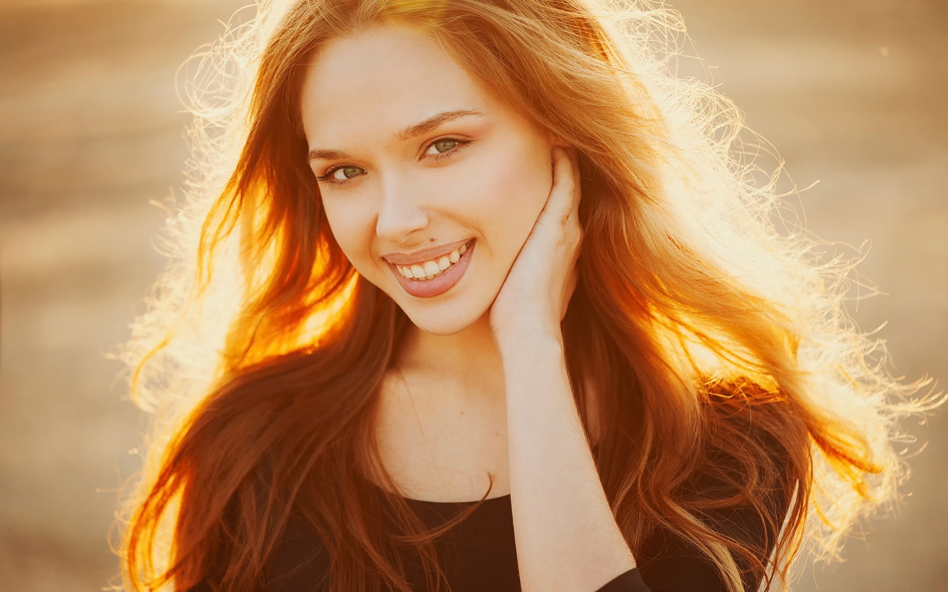 Young woman with red hair smiling in sunlight HD Wallpaper