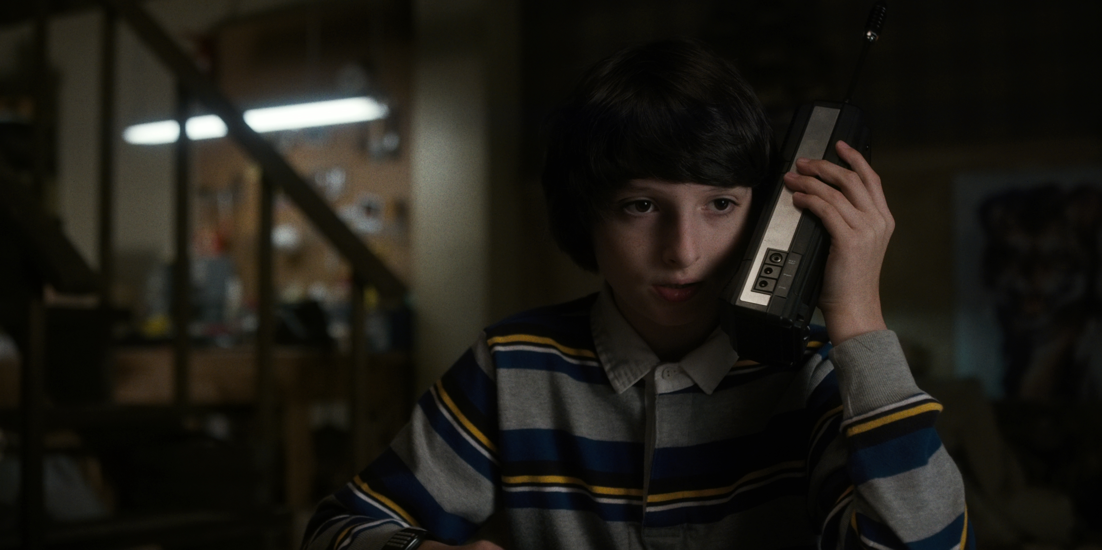 Finn Wolfhard holding a walkie-talkie HD Wallpaper