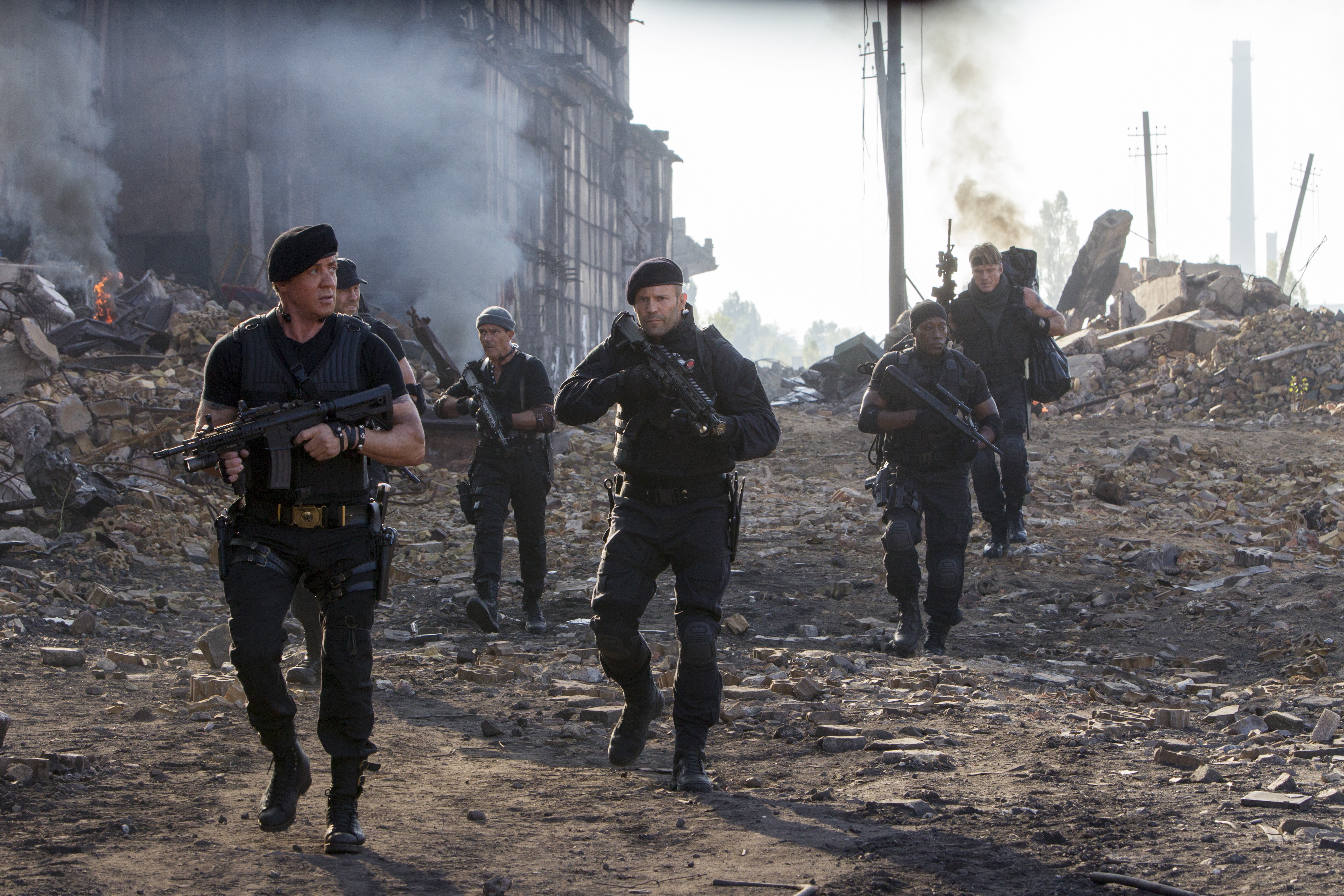 The Expendables walking through rubble HD Wallpaper