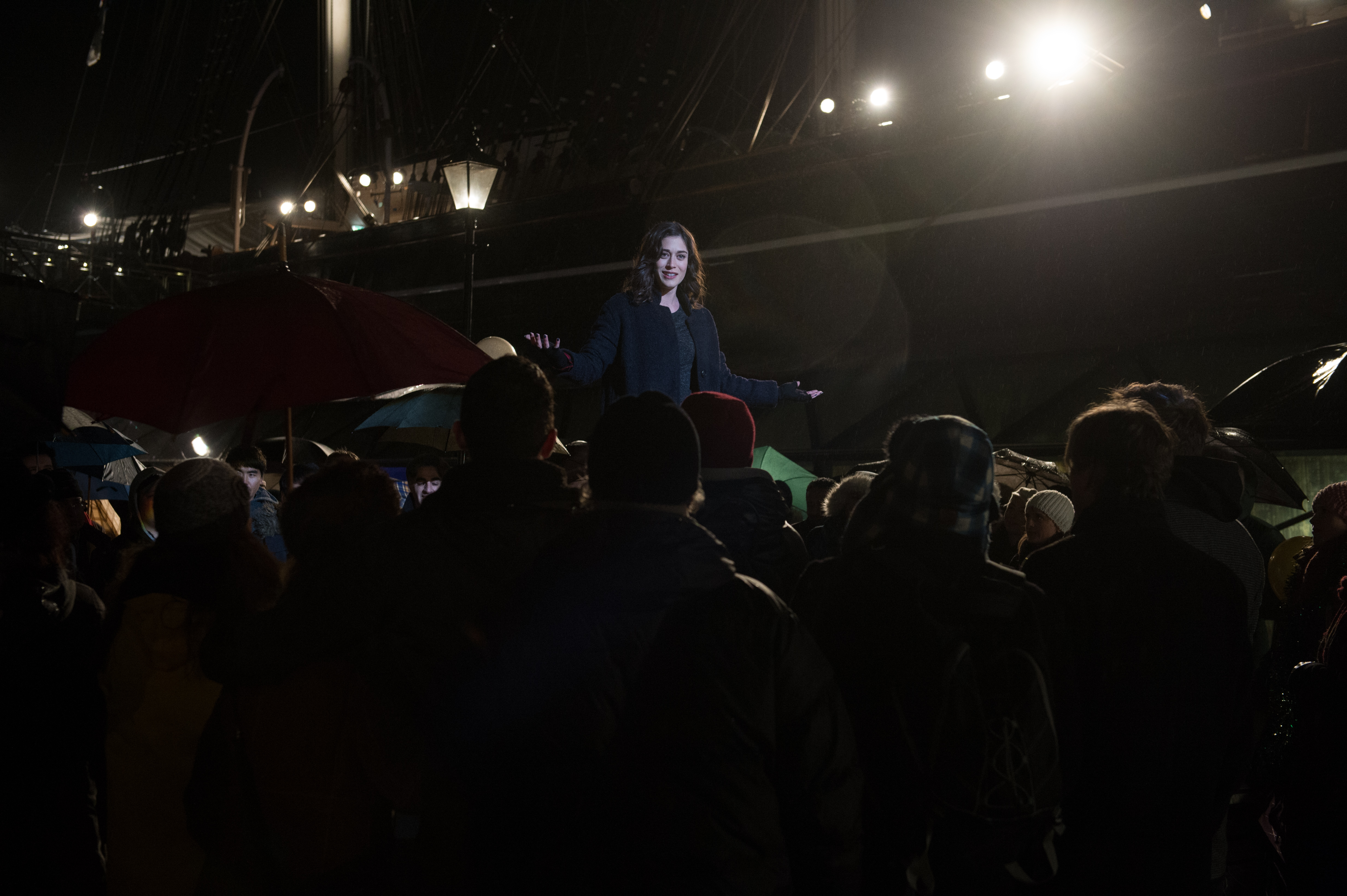 Lizzy Caplan speaking to a crowd at night HD Wallpaper