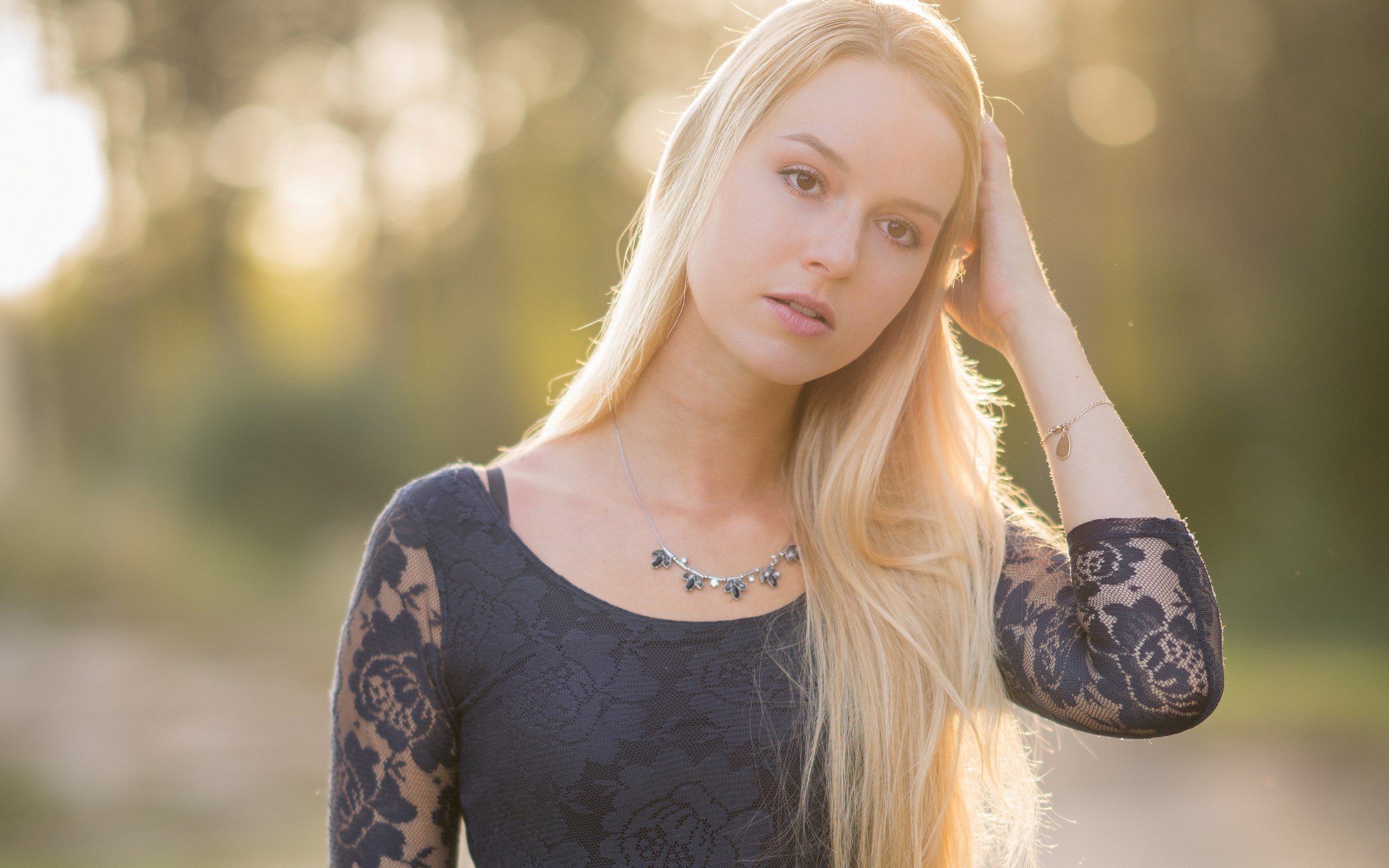 Young woman with blonde hair wearing a dark lace dress HD Wallpaper