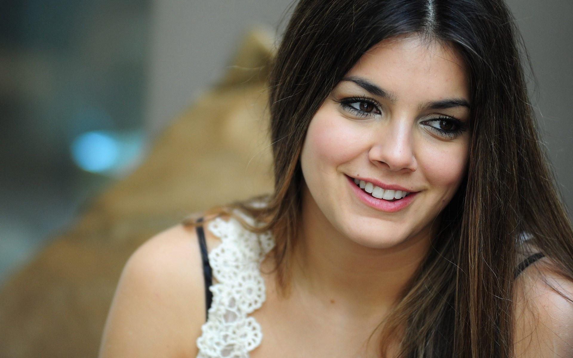 Woman with dark hair smiling HD Wallpaper