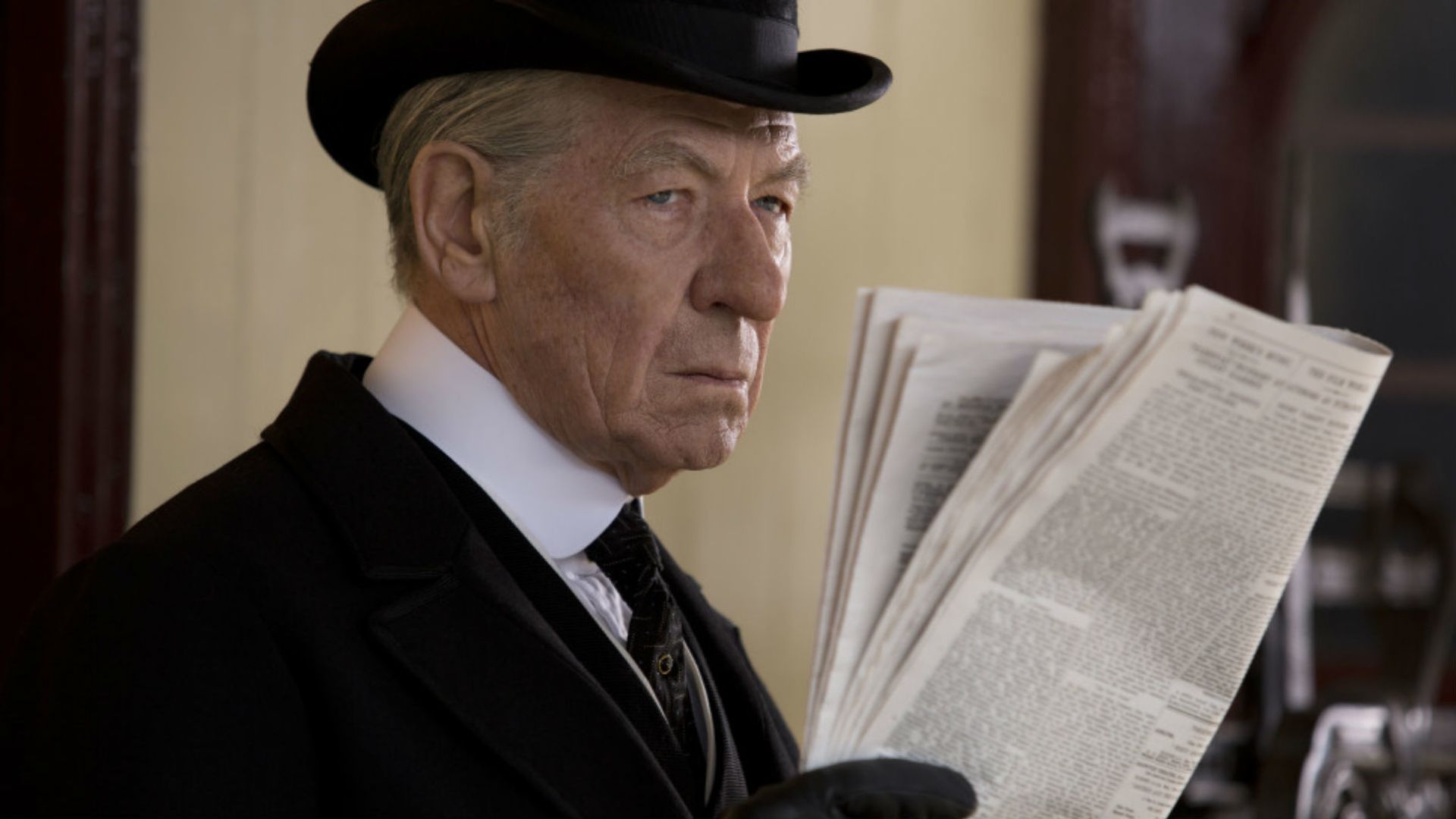 Ian McKellen reading a newspaper HD Wallpaper