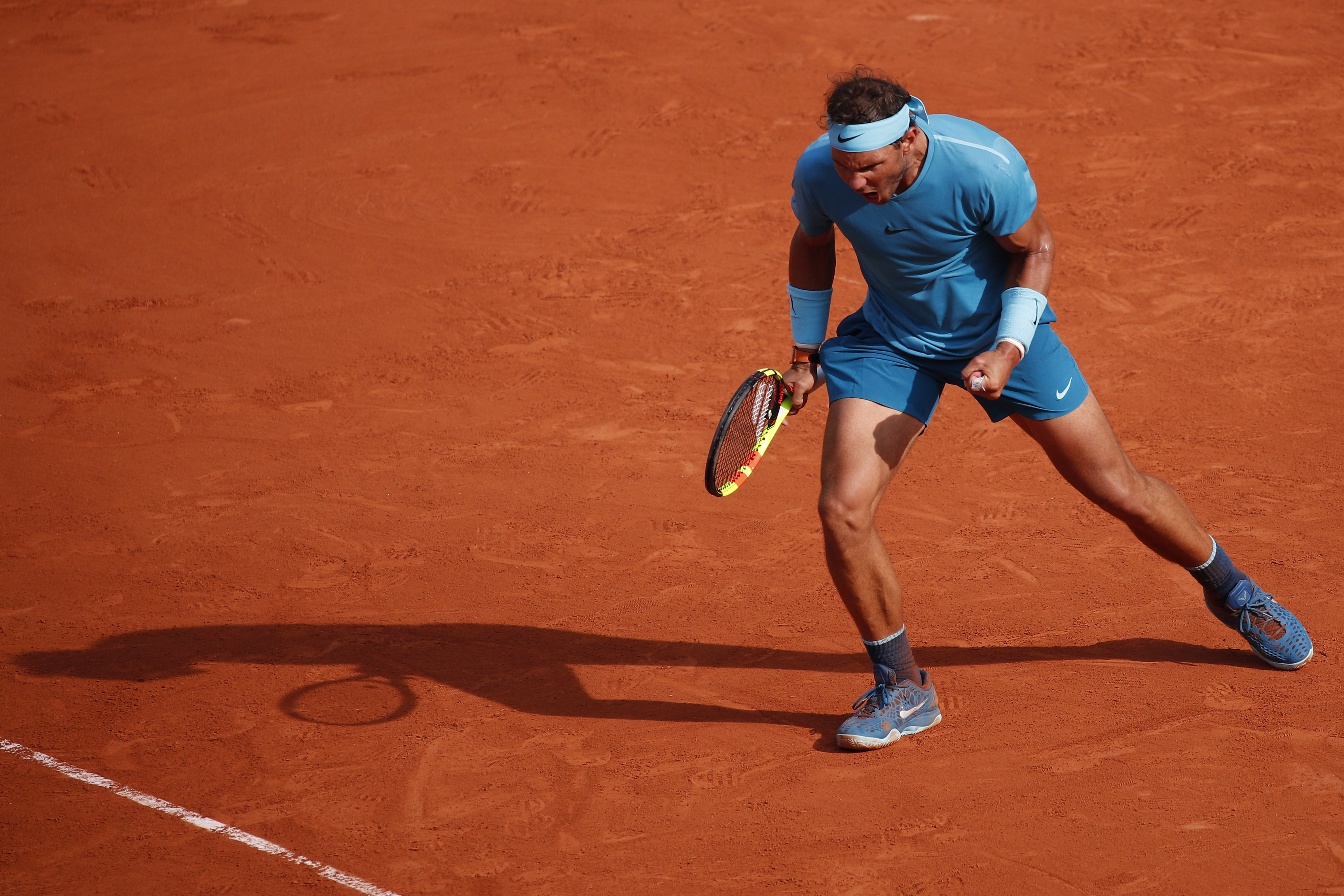 Rafael Nadal on a clay tennis court HD Wallpaper