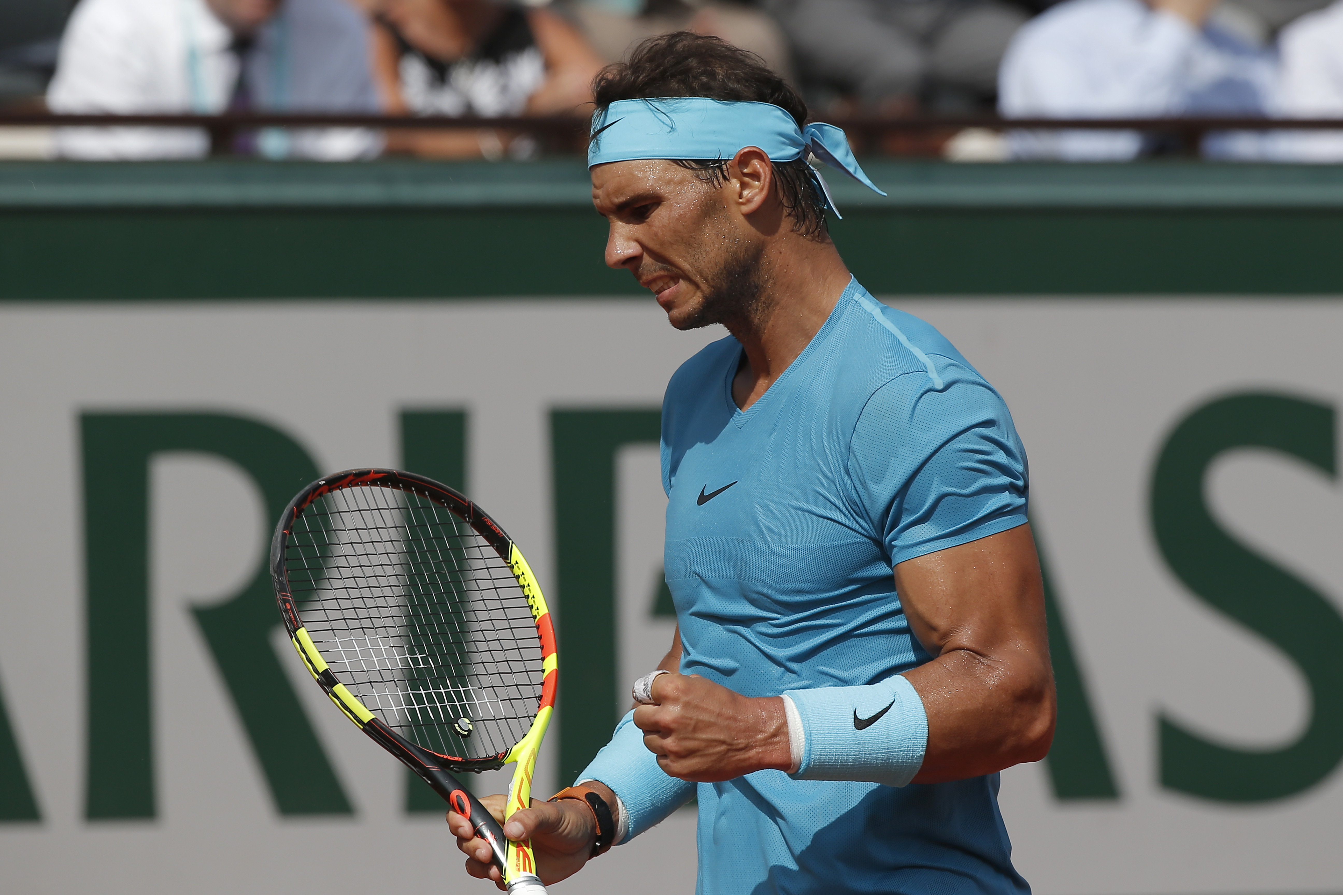 Rafael Nadal playing tennis on a clay court HD Wallpaper