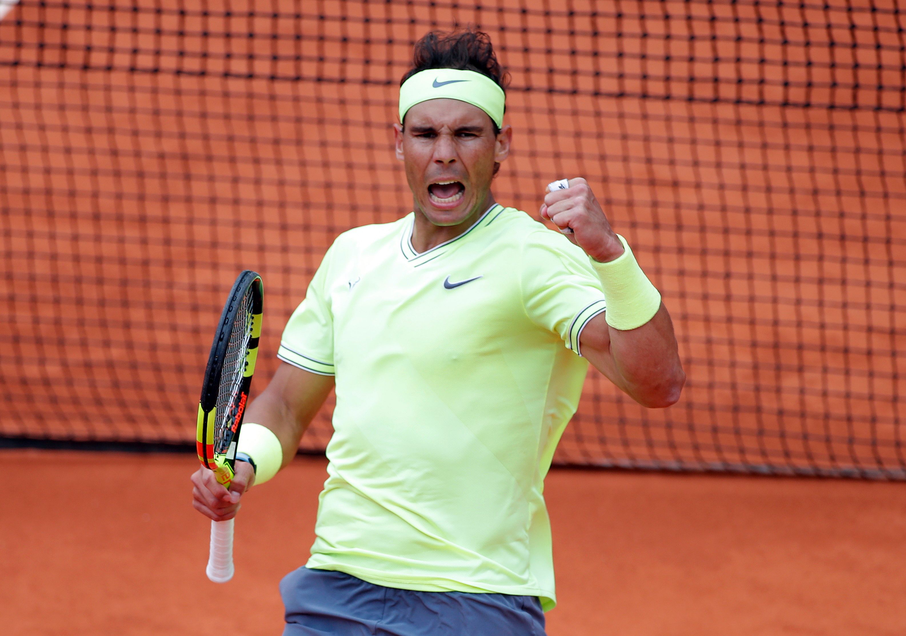 Rafael Nadal on a clay tennis court HD Wallpaper