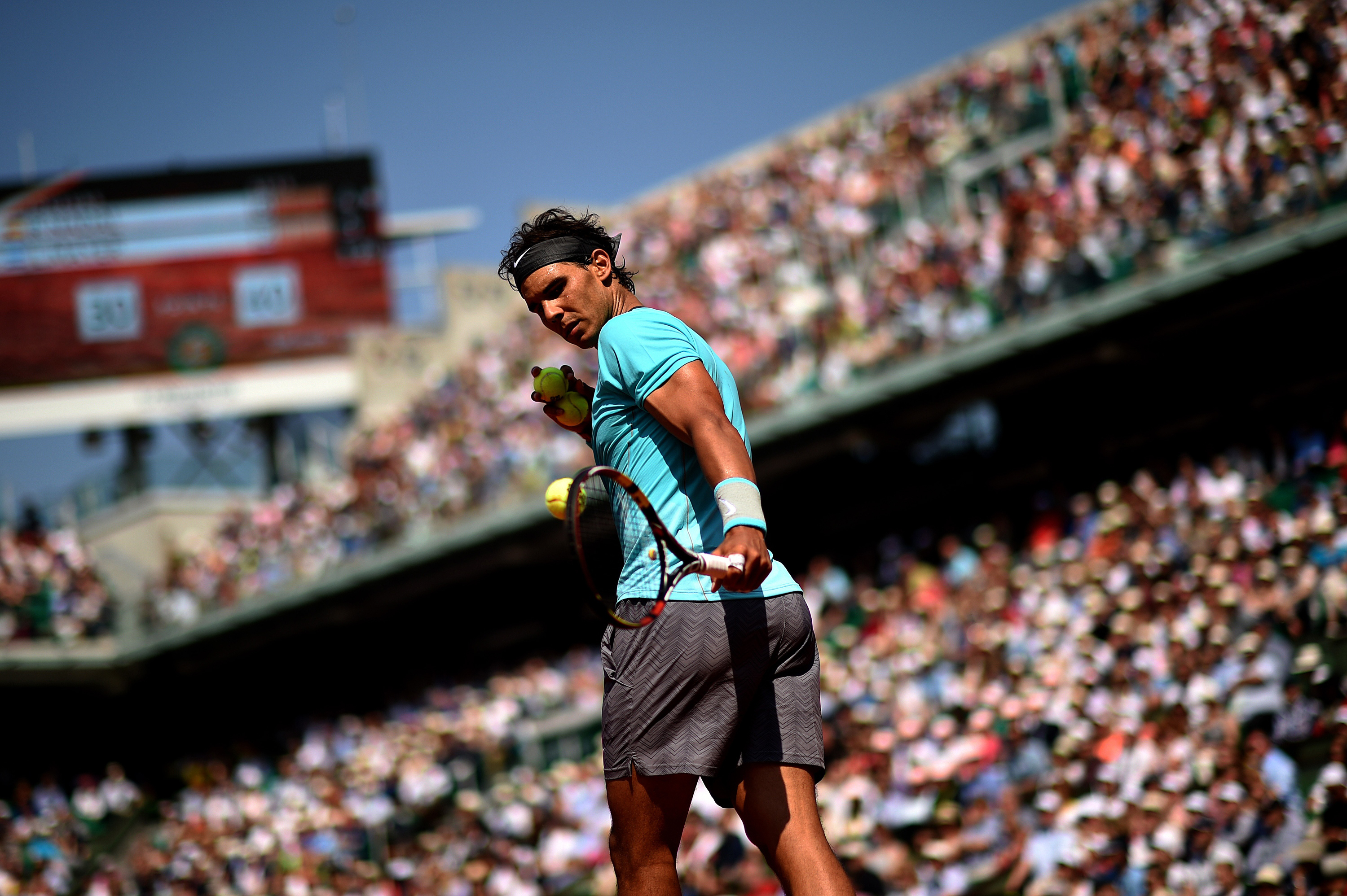Rafael Nadal holding tennis balls and racket HD Wallpaper