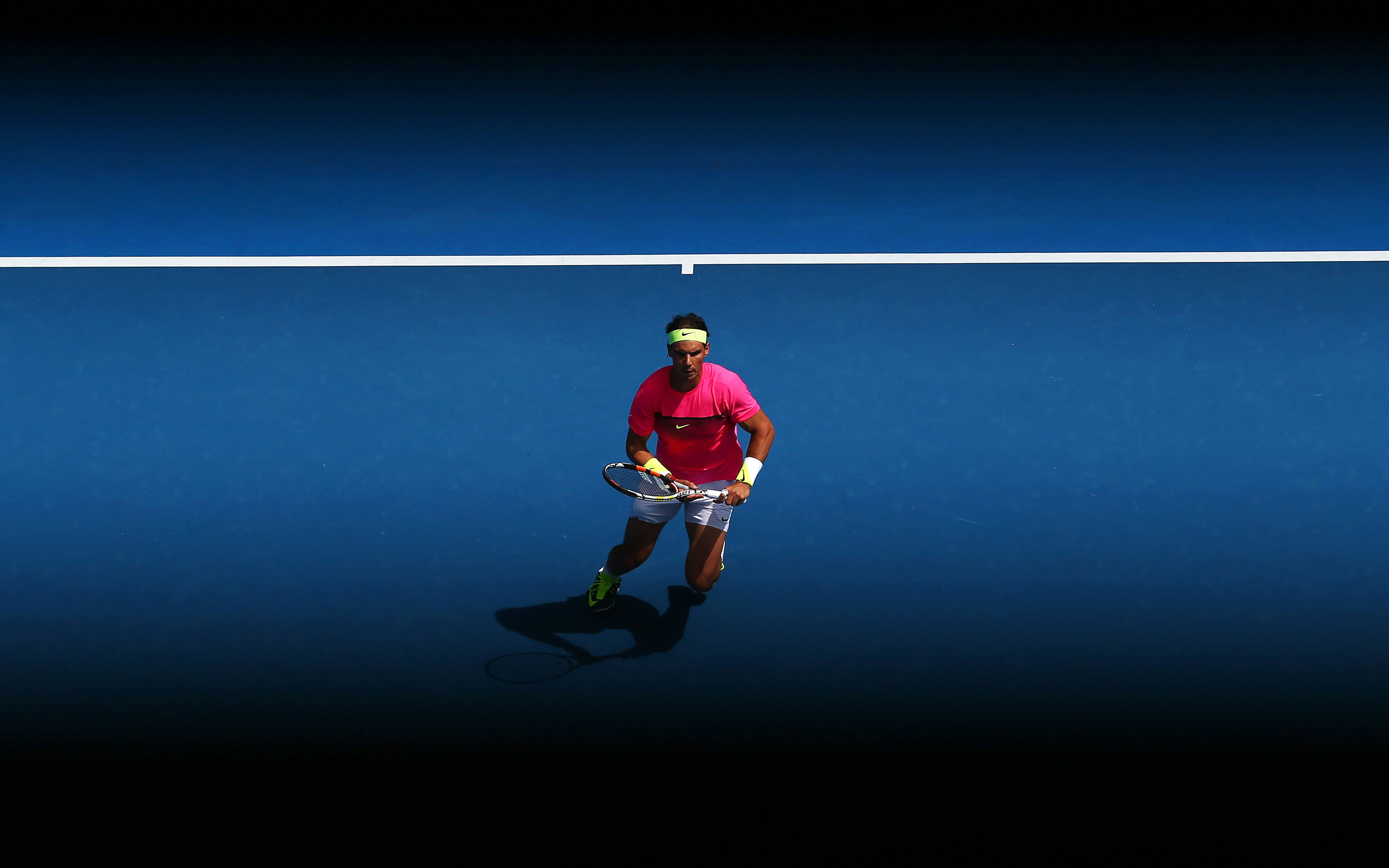 Rafael Nadal on a blue tennis court HD Wallpaper