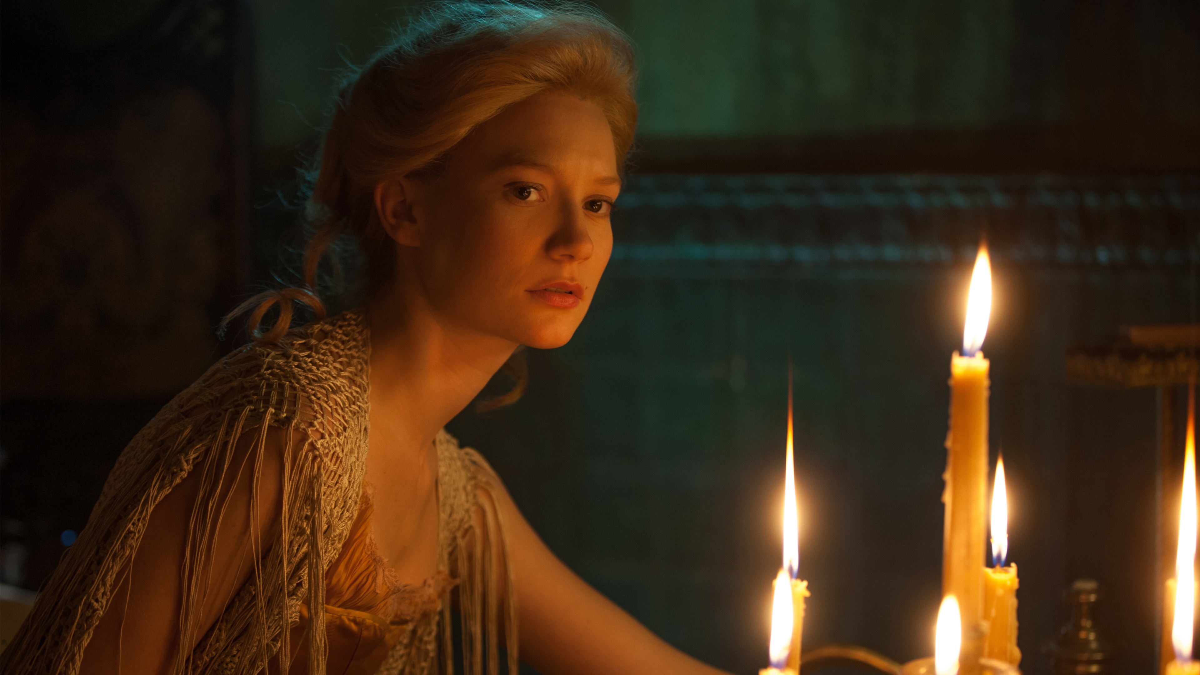 Mia Wasikowska in dimly lit room with candles HD Wallpaper