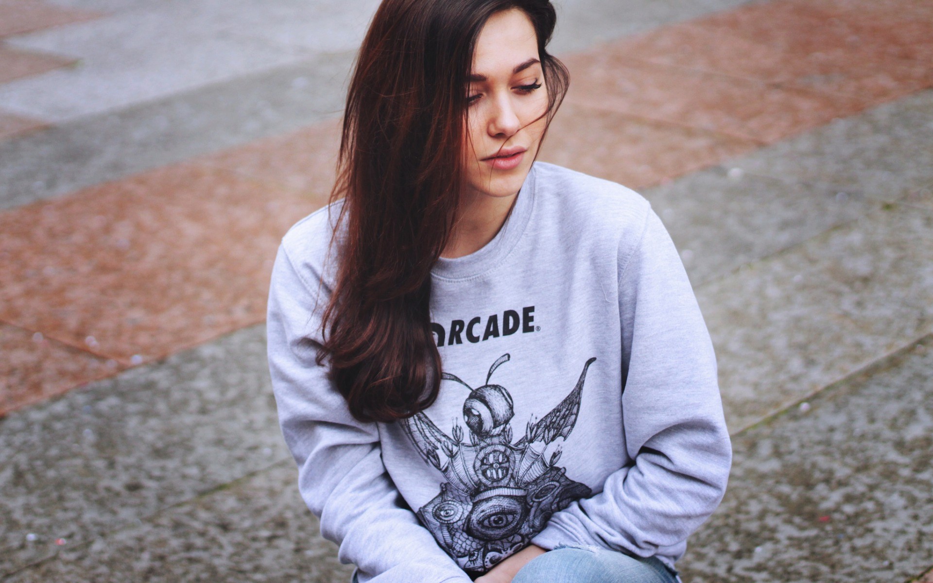 Woman wearing a grey sweatshirt with a graphic print HD Wallpaper