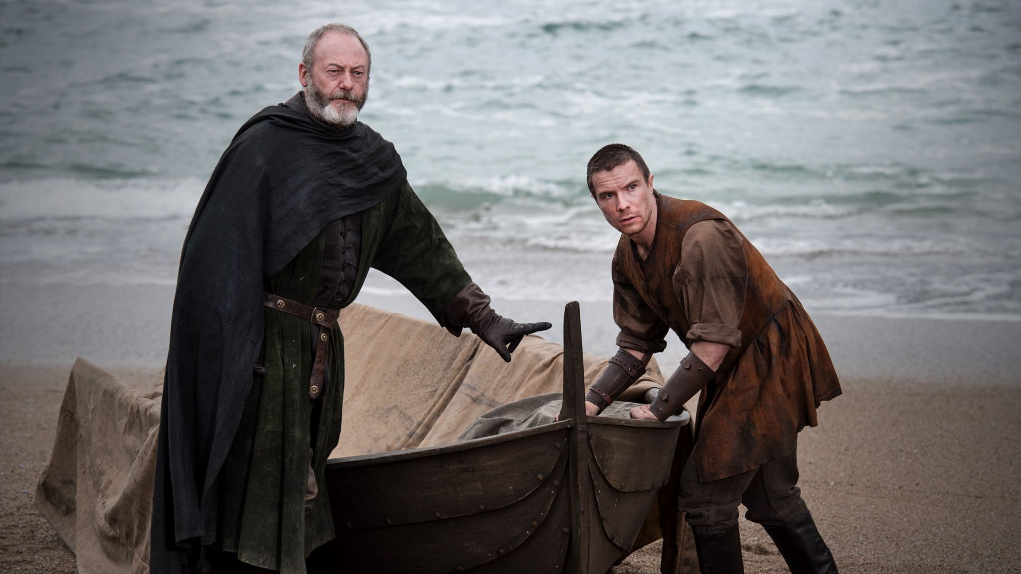 Liam Cunningham and Joe Dempsie on a beach HD Wallpaper