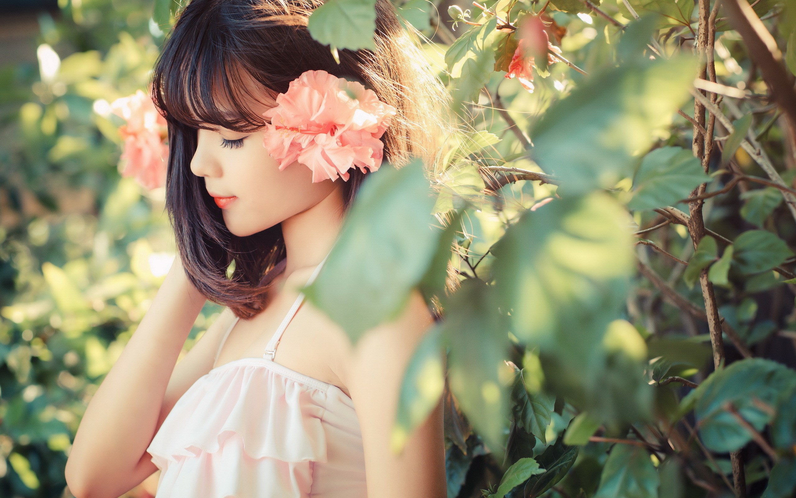 Young woman with flowers in her hair HD Wallpaper