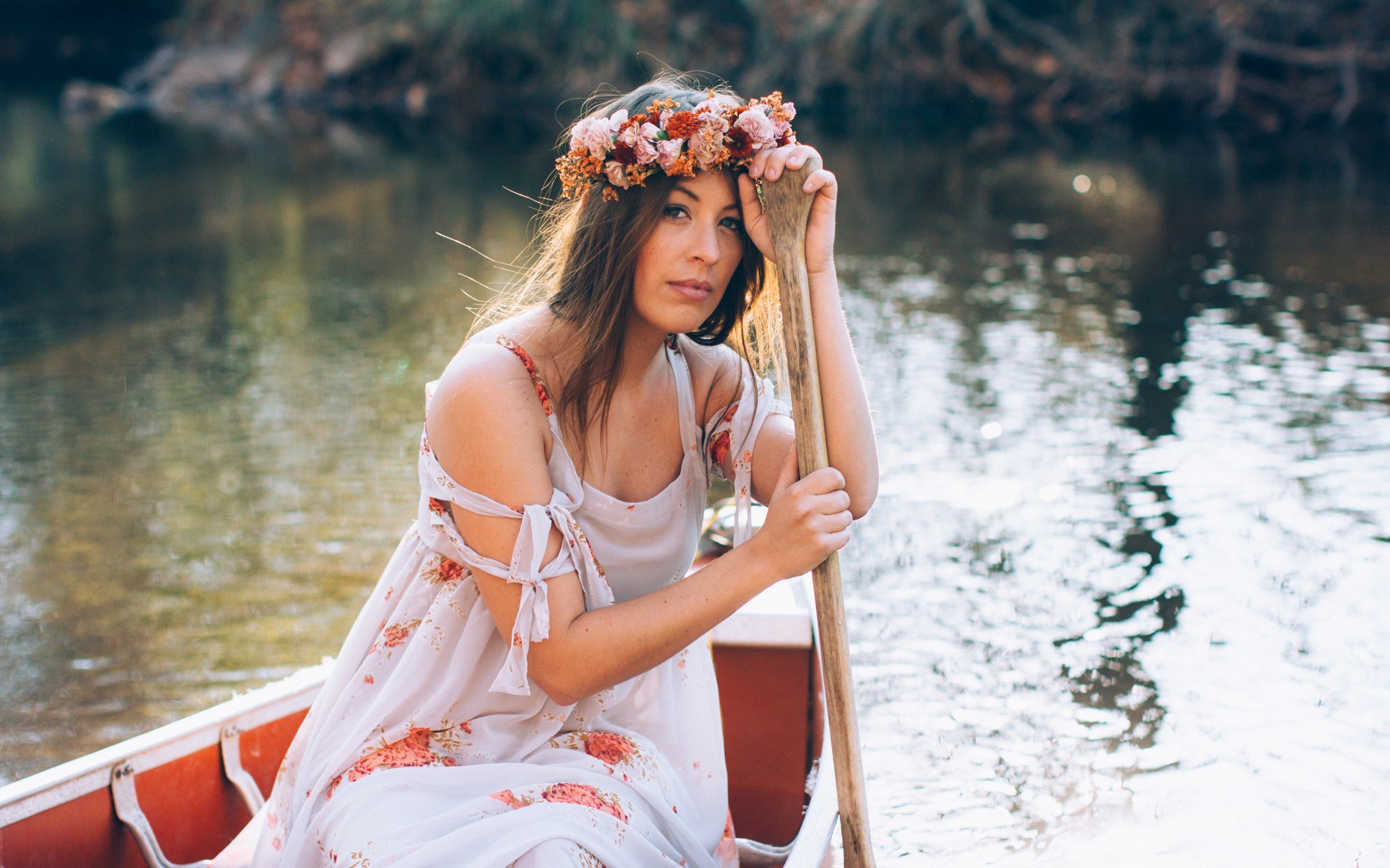 Woman in floral dress in a canoe with a paddle HD Wallpaper
