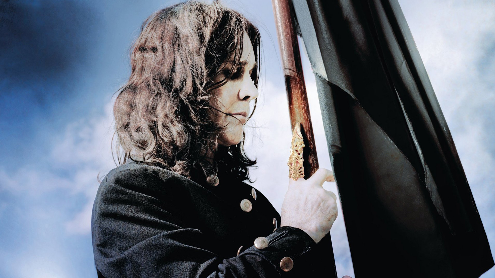 Ozzy Osbourne holding a black flag HD Wallpaper